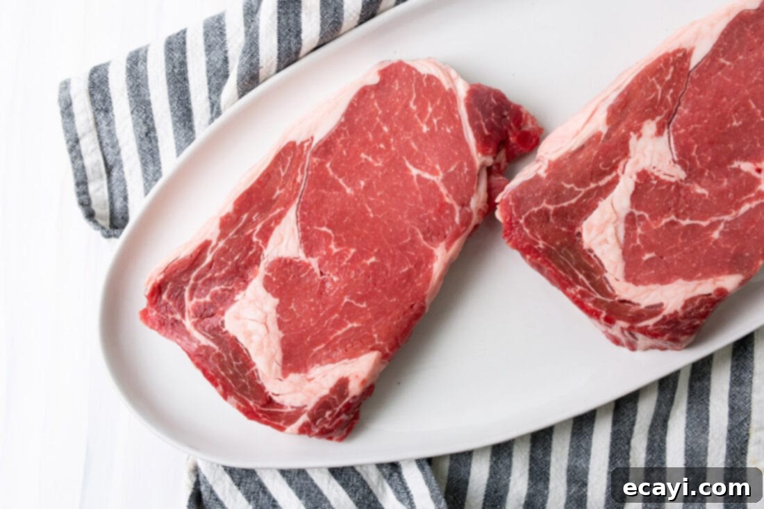 Perfectly Grilled Steak 4 Ingredients for Grilled Steak: raw New York Strip steaks, coarse salt, pepper, and butter