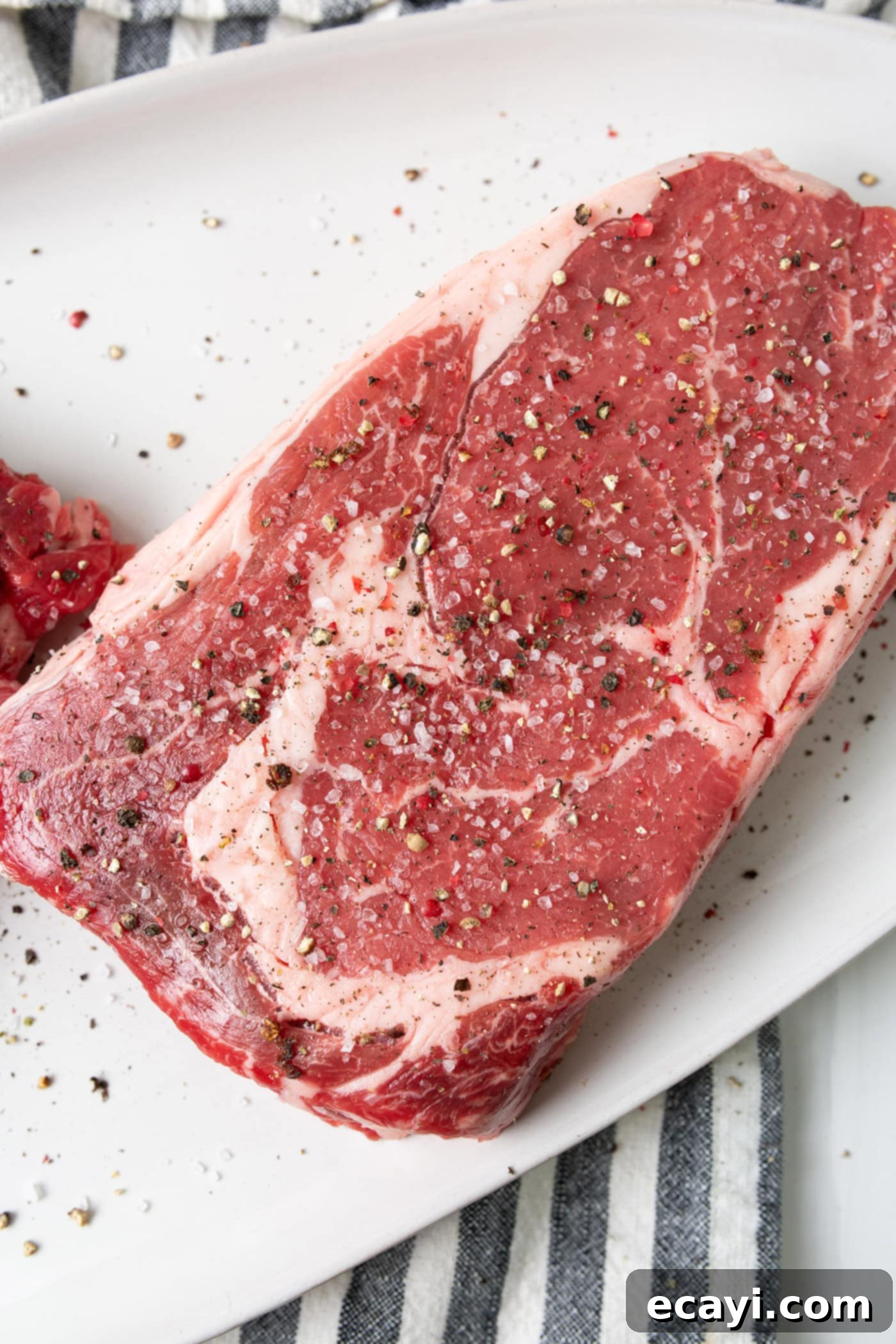 Perfectly Grilled Steak 5 Steak generously seasoned with coarse salt and pepper, ready for grilling