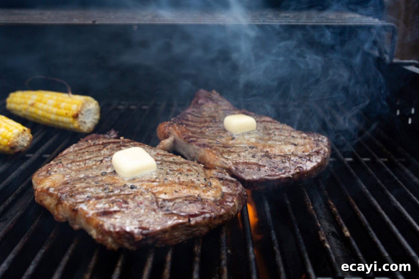 Perfectly Grilled Steak 7 Pats of butter melting on grilled New York strip steaks, basting the meat