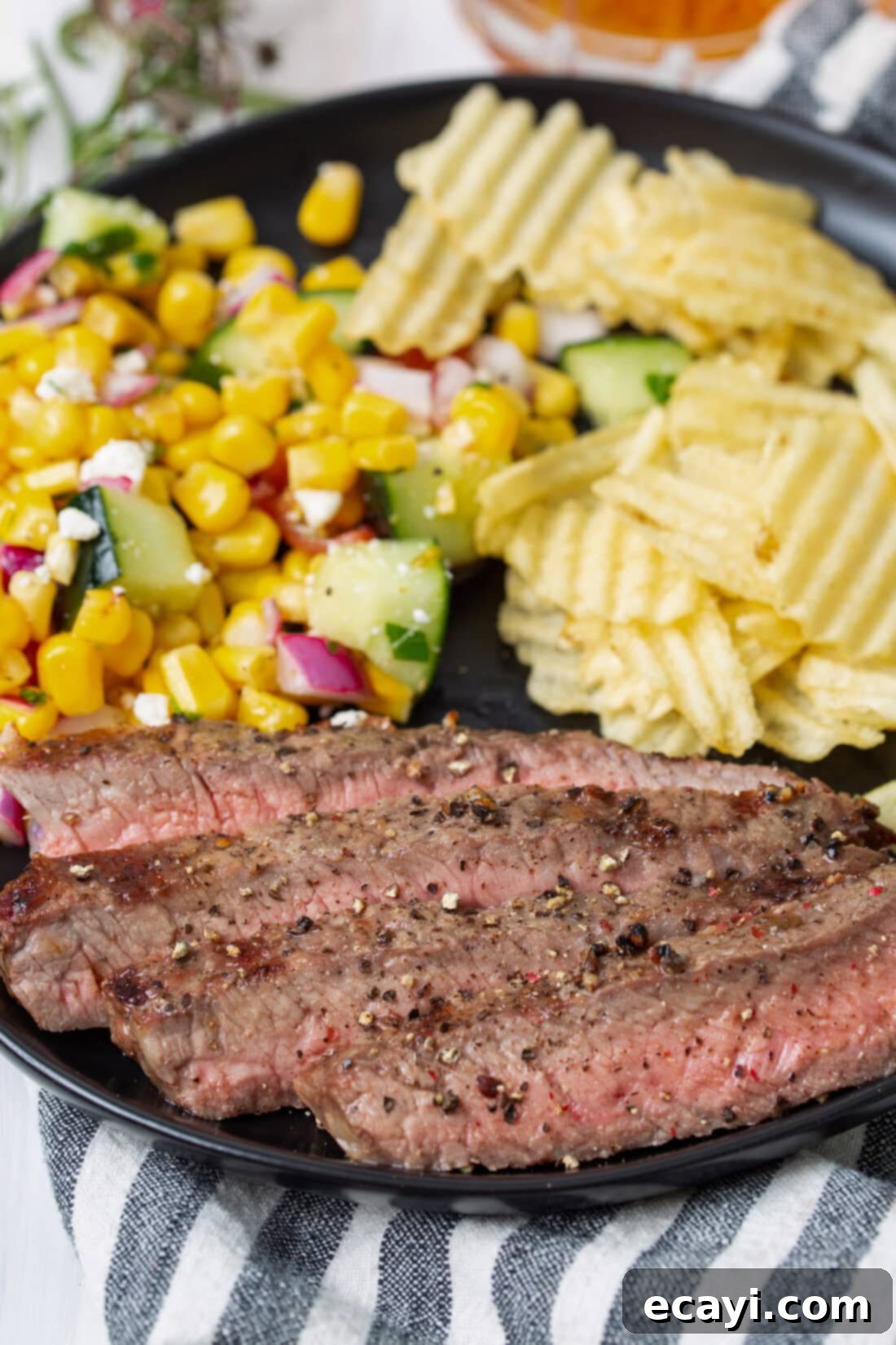 Perfectly Grilled Steak 9 Grilled New York Strip Steak on a plate with corn and mashed potatoes, ready to serve