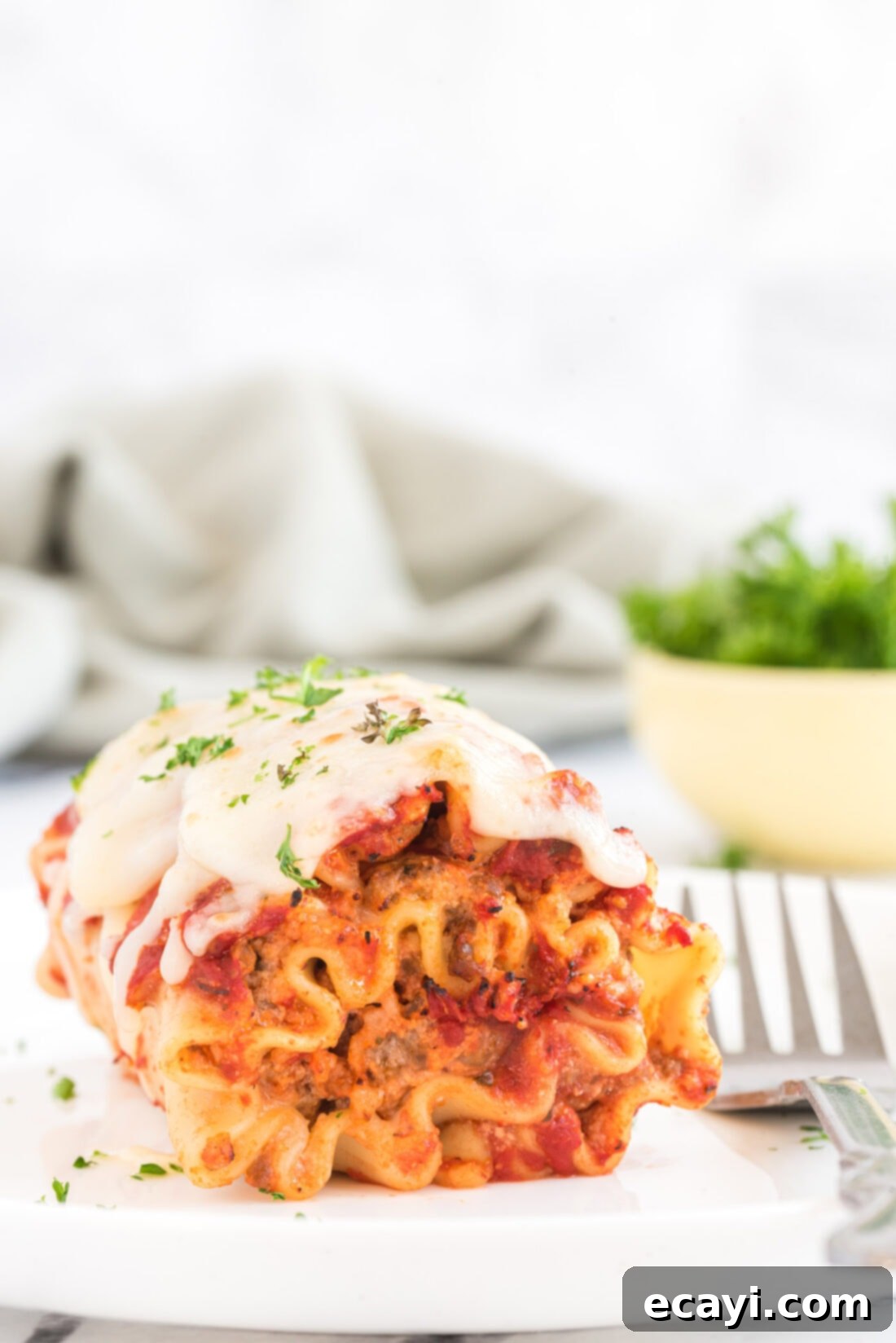 Lasagna Pinwheels 5 Lasagna Roll Up with a fork on a plate