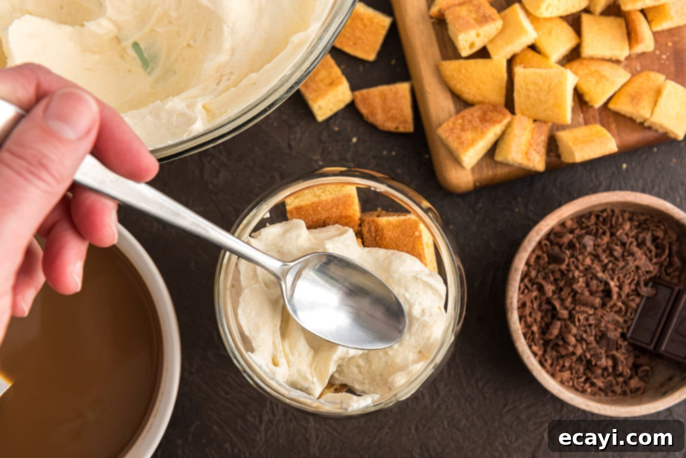 Bailey's Irish Dream Parfaits 12 spooning mascarpone cheese mixture over ladyfingers in a dish