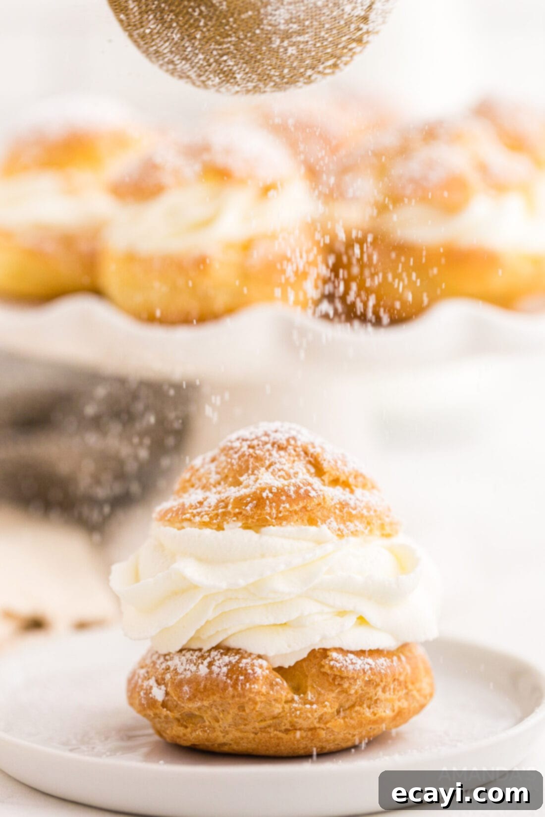 Golden Choux Delights 2 sifting powdered sugar on top of a Cream Puff