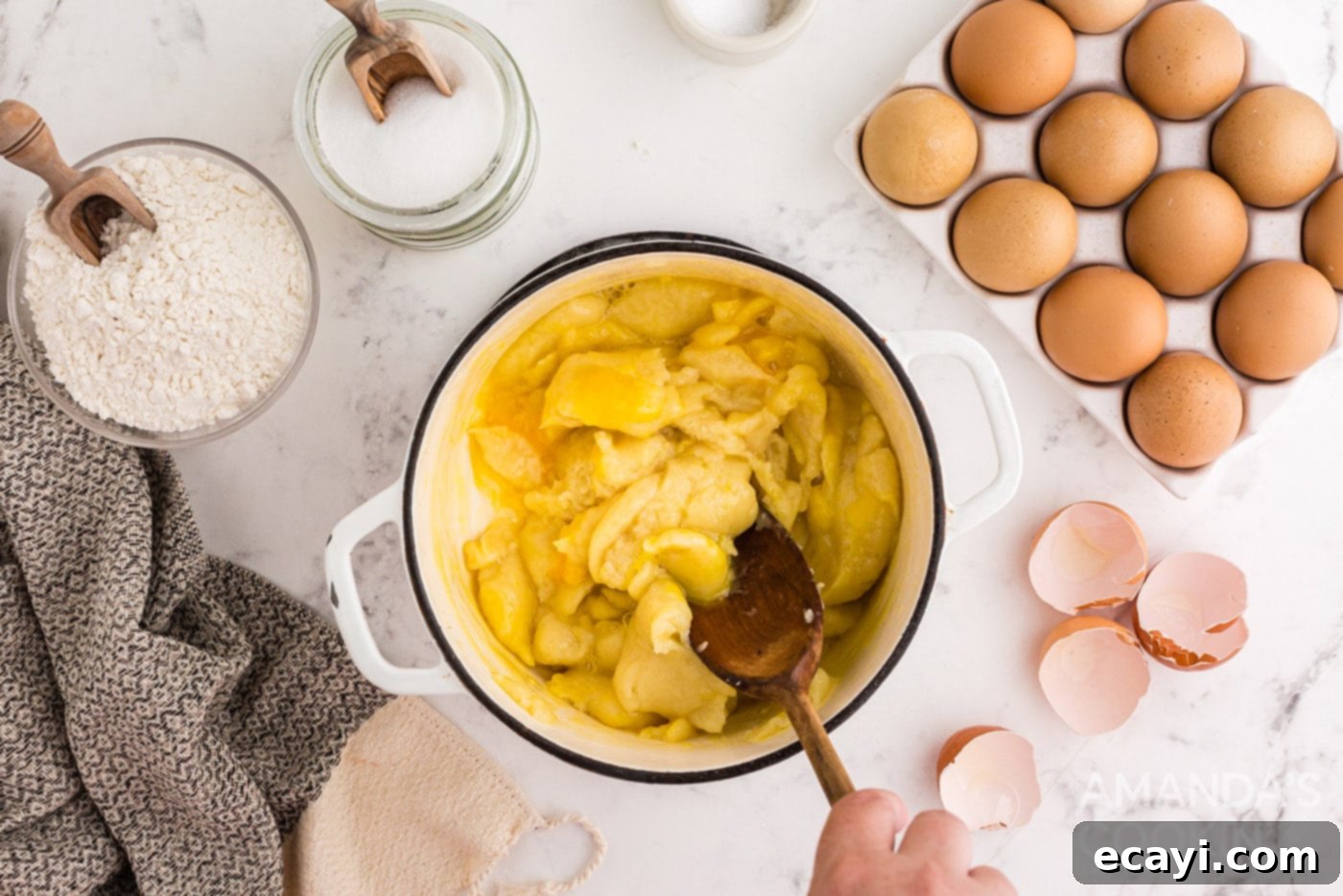Golden Choux Delights 8 dough in a saucepan with wooden spoon