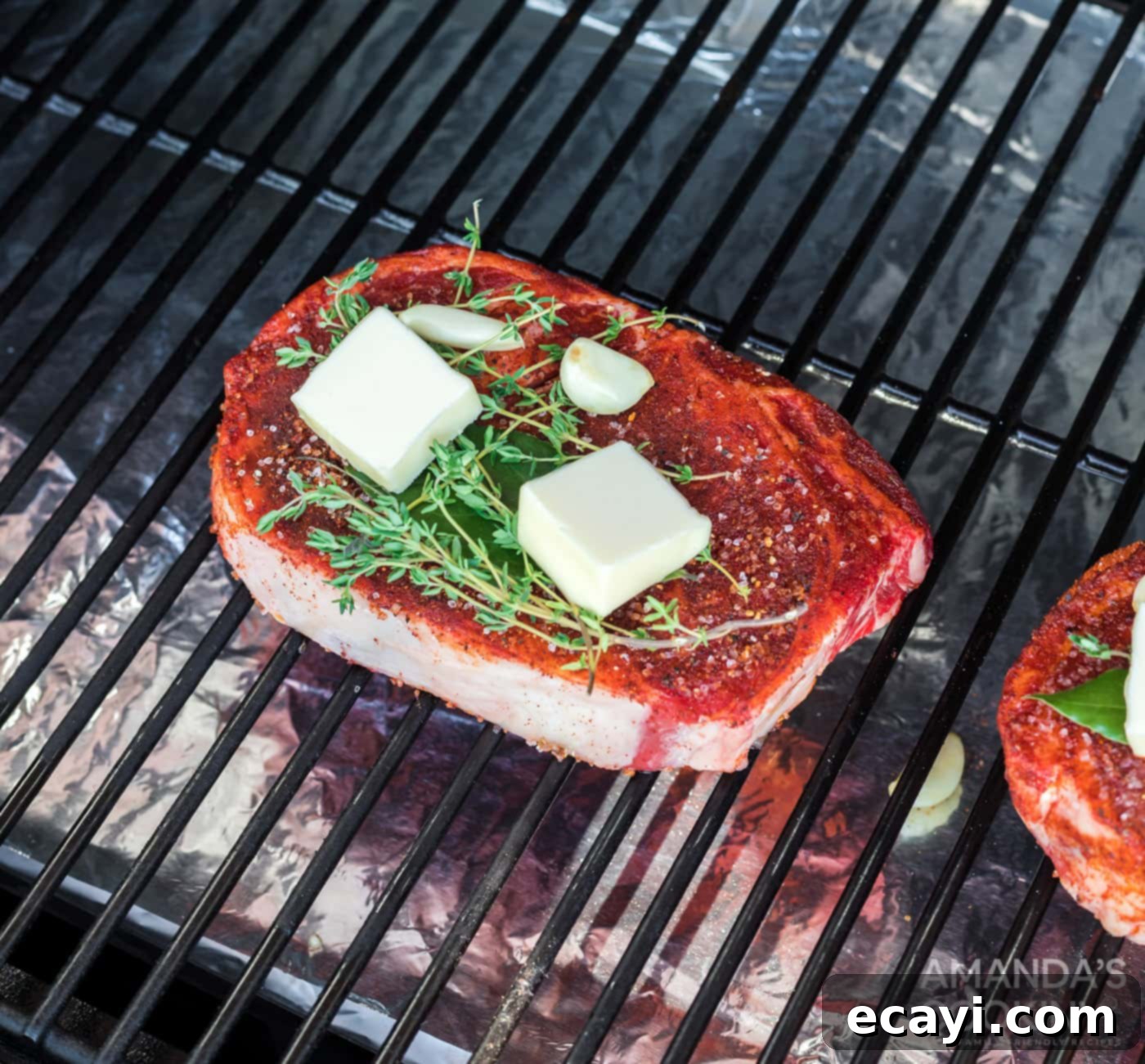 Slow-Smoked Ribeye 8 Two ribeye steaks smoking on the grill grates inside a smoker, enveloped in a savory aroma.