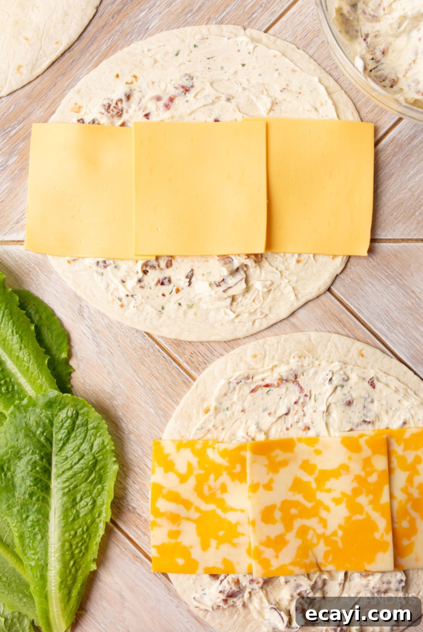 Swirl Sandwiches 7 Cheese slices arranged on a tortilla with cream cheese spread