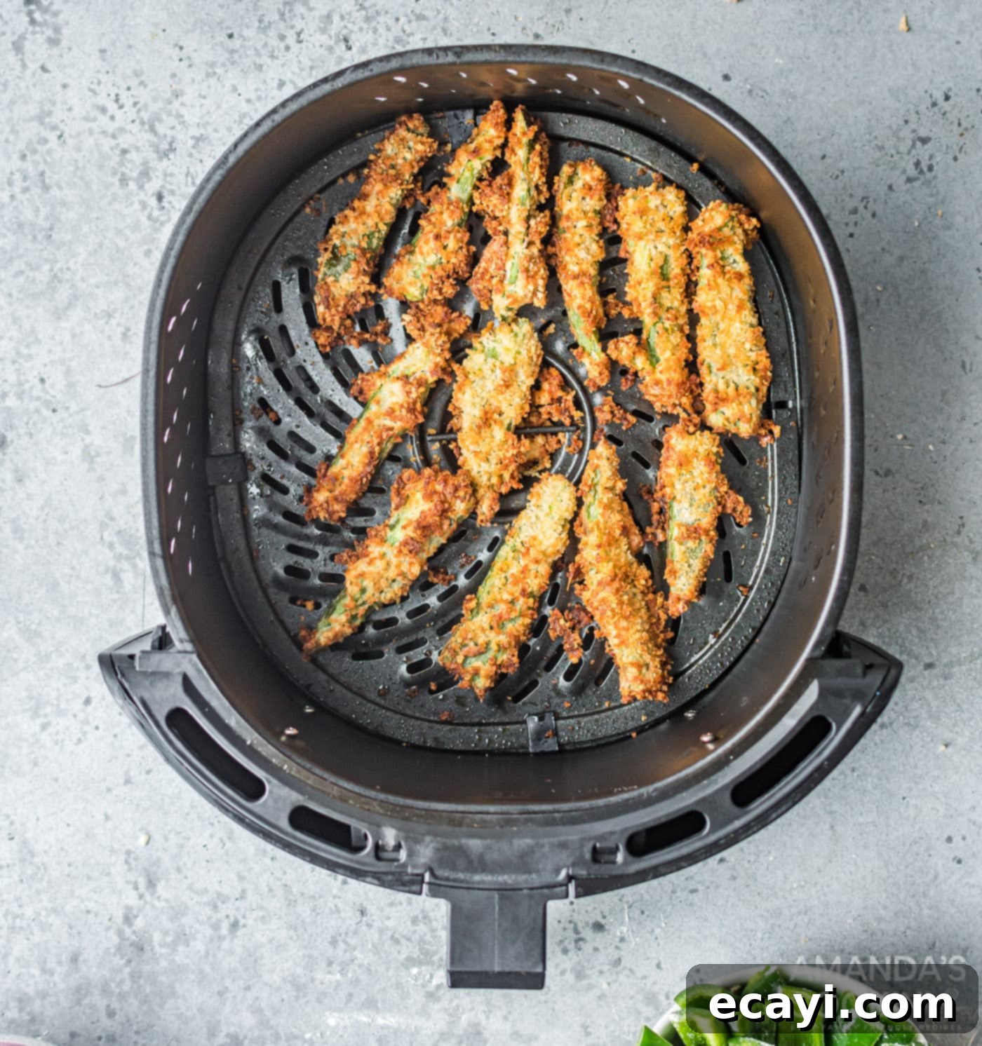 Crispy Air Fryer Jalapeño Fries 7 Golden brown cooked jalapeno fries scattered in the air fryer basket, showing their crisp texture