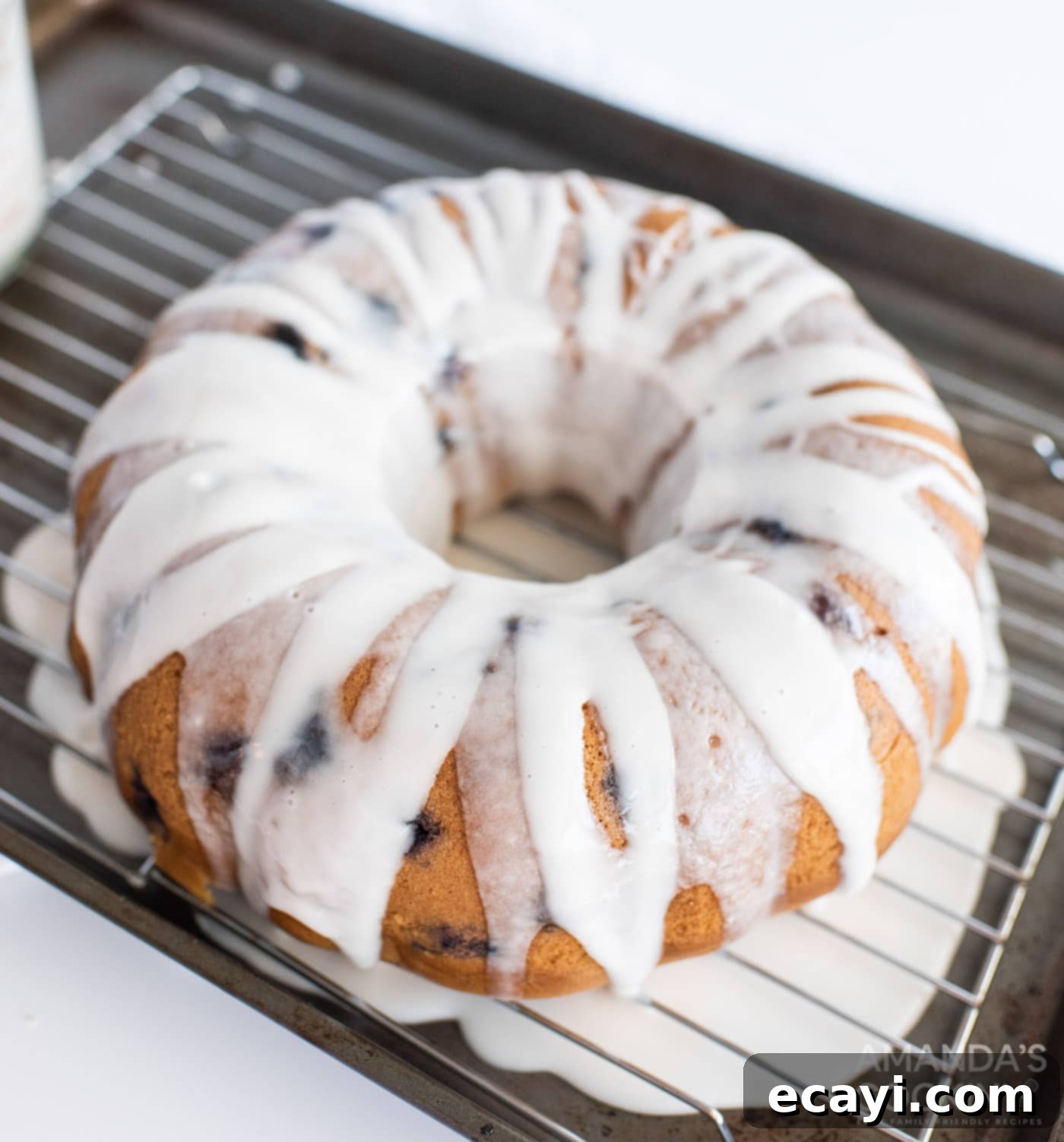 Blueberry Bliss Bundt 9 A freshly glazed blueberry bundt cake adorned with extra fresh blueberries