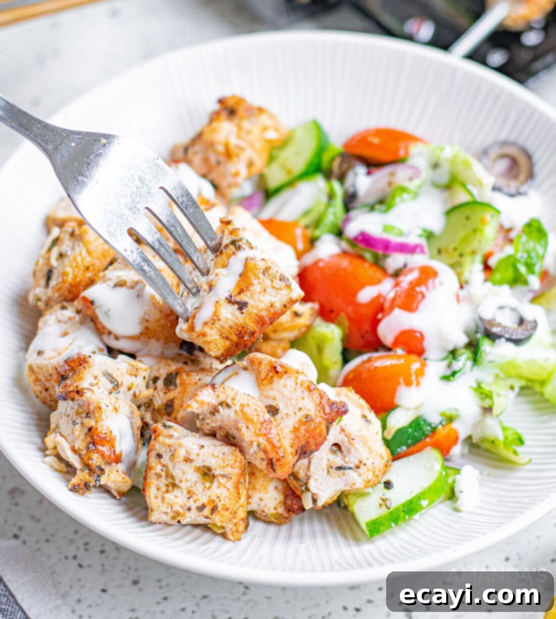 Lemon-Herb Mediterranean Chicken Skewers 11 Final plated Greek Chicken Kabobs with a large, fresh salad