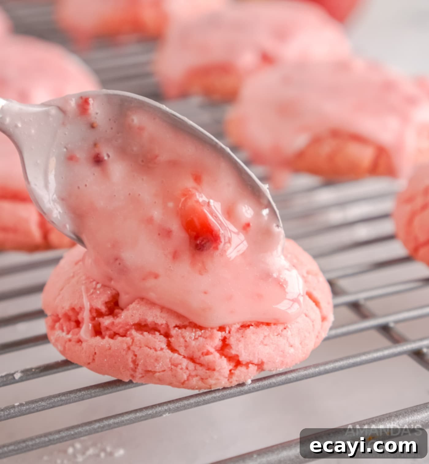 Easy Strawberry Cake Mix Cookies 11 spooning strawberry glaze over cookies