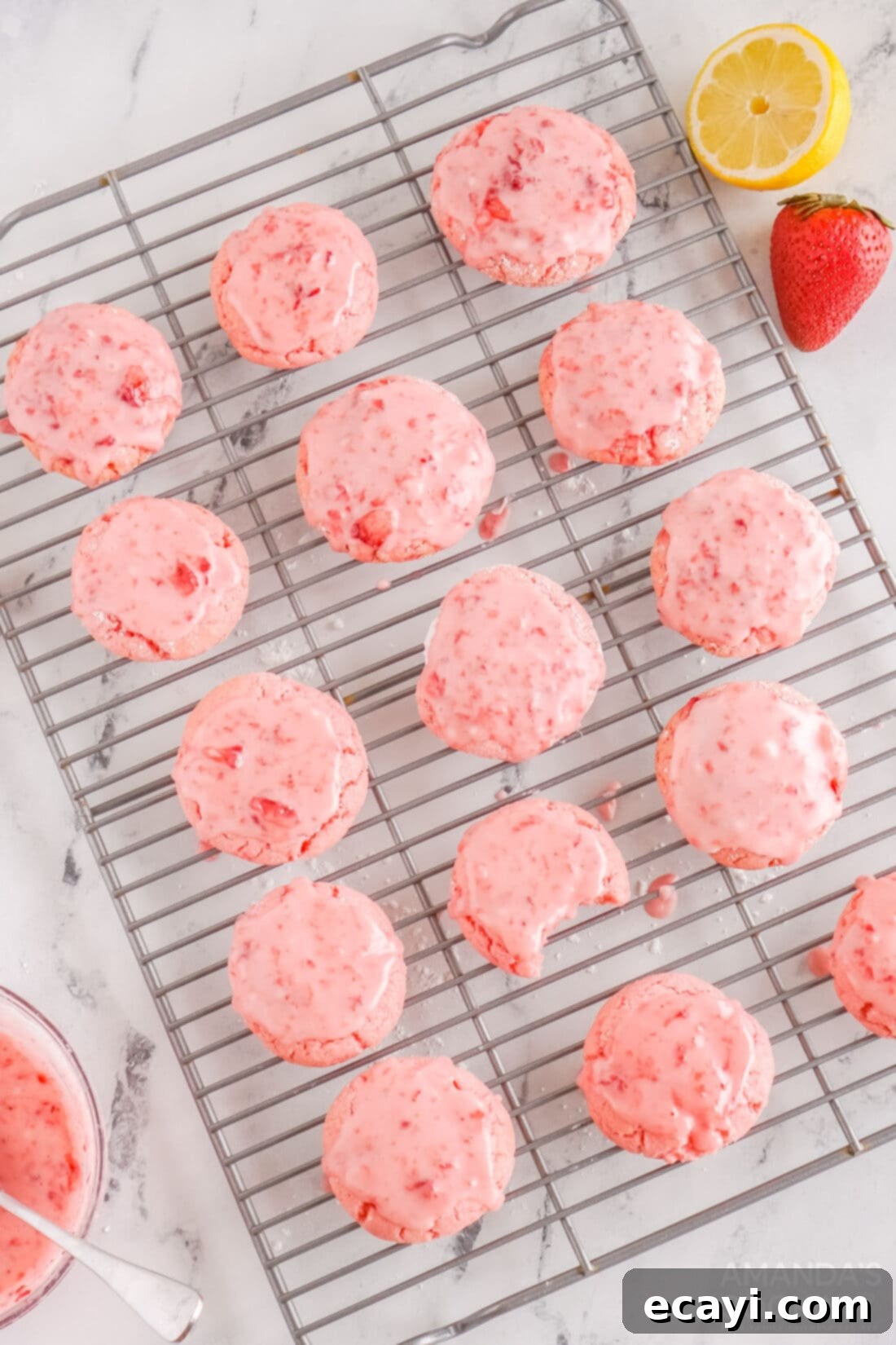 Easy Strawberry Cake Mix Cookies 3 wire rack of freshly baked Strawberry Cookies cooling with pink glaze