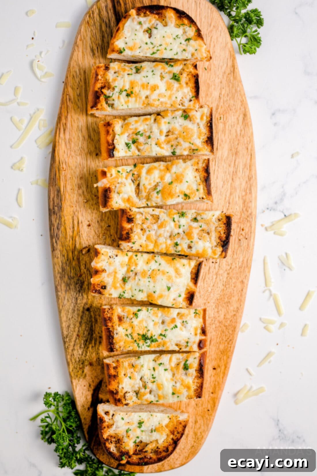Garlic Cheese Bliss 3 Freshly baked and sliced Cheesy Garlic Bread arranged on a wooden cutting board
