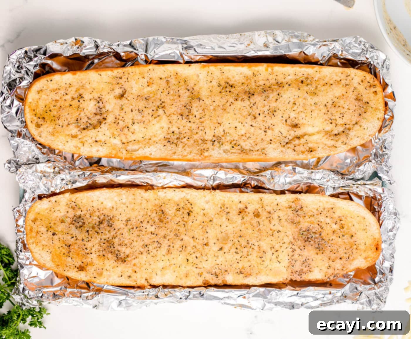 Garlic Cheese Bliss 8 Baked French bread halves, lightly browned at the edges, on a baking sheet