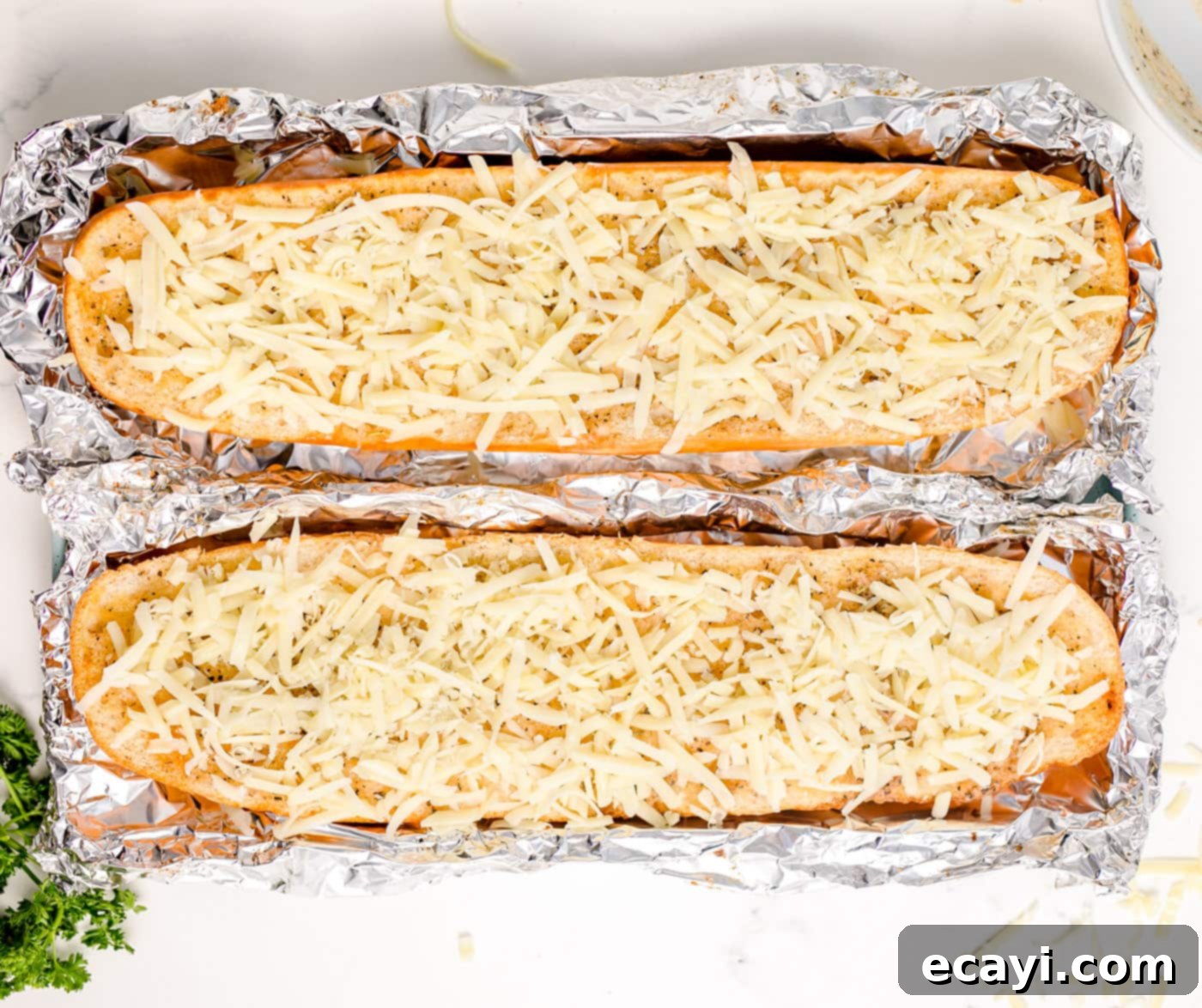 Garlic Cheese Bliss 9 Cheesy garlic bread with melted mozzarella on a pan lined with aluminum foil, ready to be removed from the oven