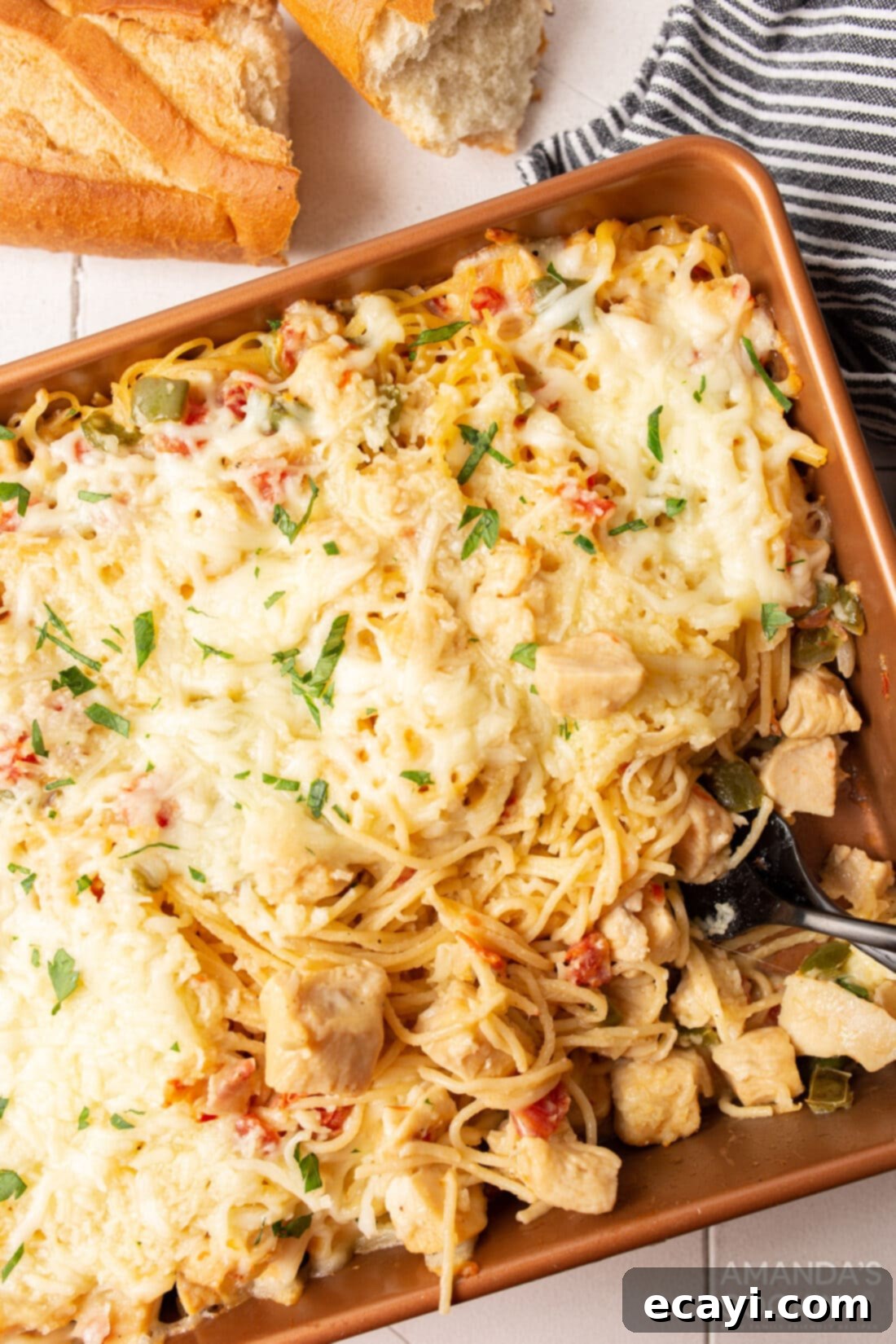 Creamy Chicken Spaghetti Bake 3 A large pan filled with golden-brown cheesy chicken spaghetti, ready to serve.