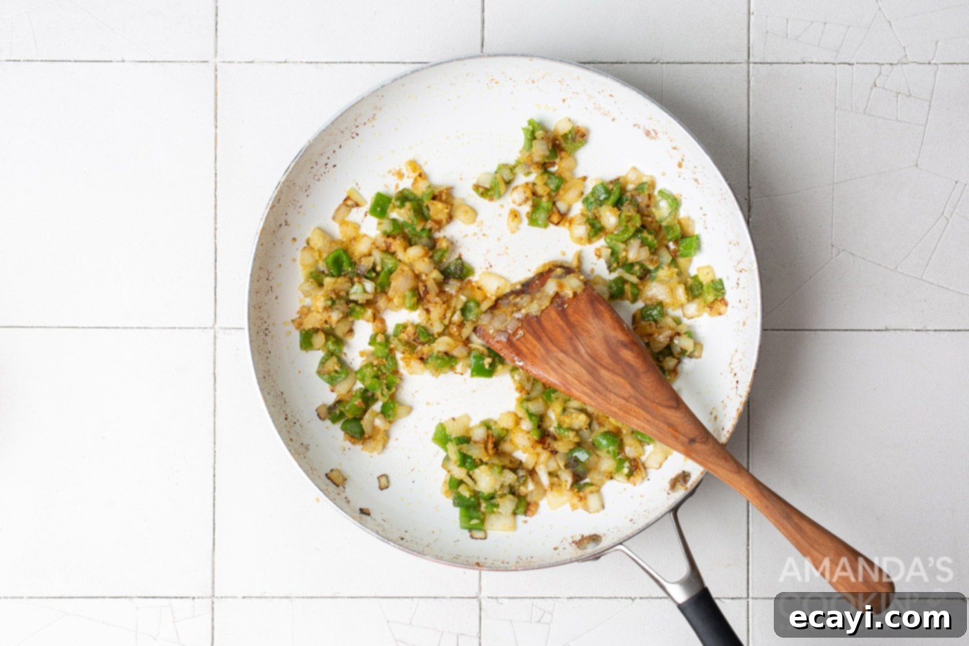 Creamy Chicken Spaghetti Bake 6 Diced garlic, onion, and green pepper sautéing in a skillet, before adding flour.