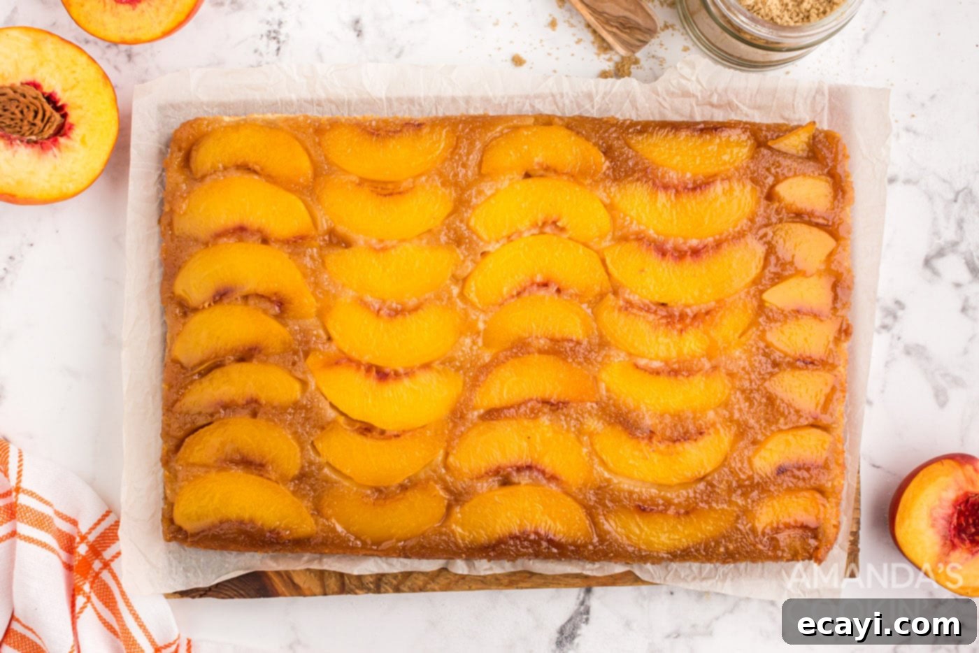 Golden Peach Crown Cake 11 Golden brown, baked peach upside down cake in a glass baking dish, fresh out of the oven.