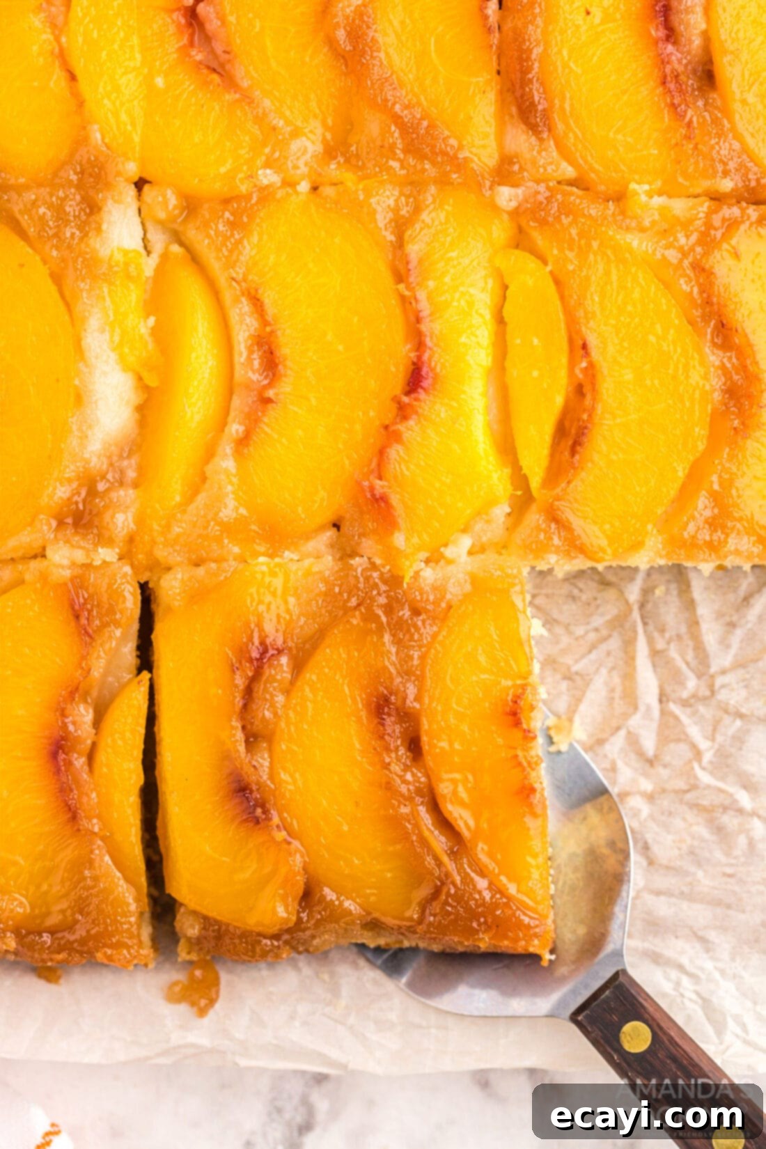 Golden Peach Crown Cake 12 Overhead shot of a beautifully sliced Peach Upside Down Cake, showing the golden caramelized peaches and fluffy cake.