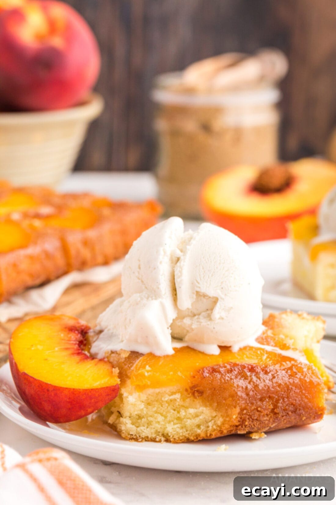 Golden Peach Crown Cake 3 Slice of Peach Upside Down Cake topped with a scoop of vanilla ice cream