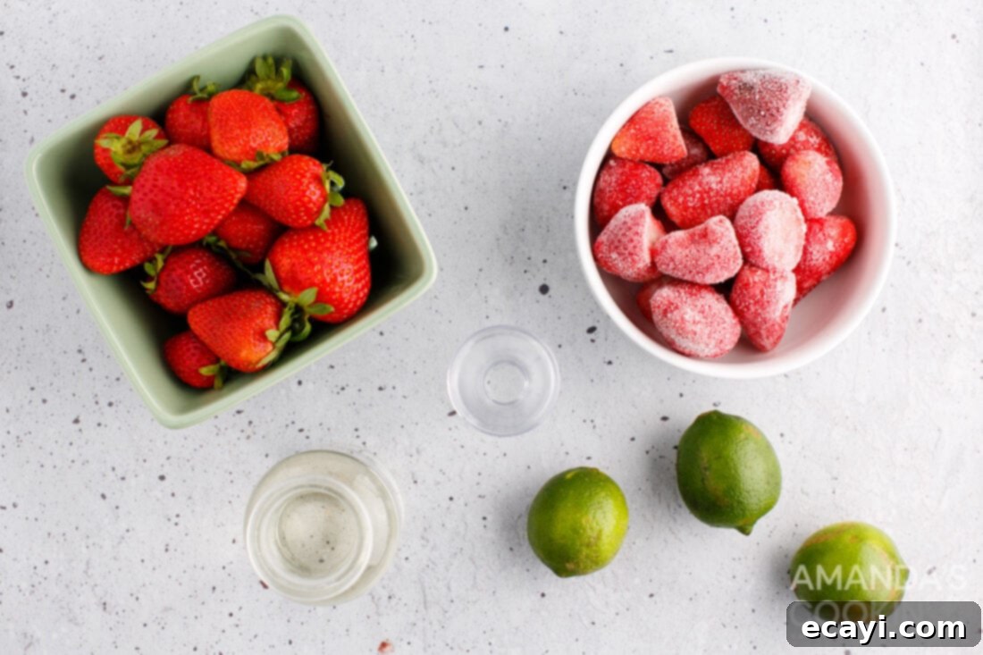 Frozen Strawberry Delight 4 ingredients for making a Strawberry Daiquiri including strawberries, rum, lime, and simple syrup