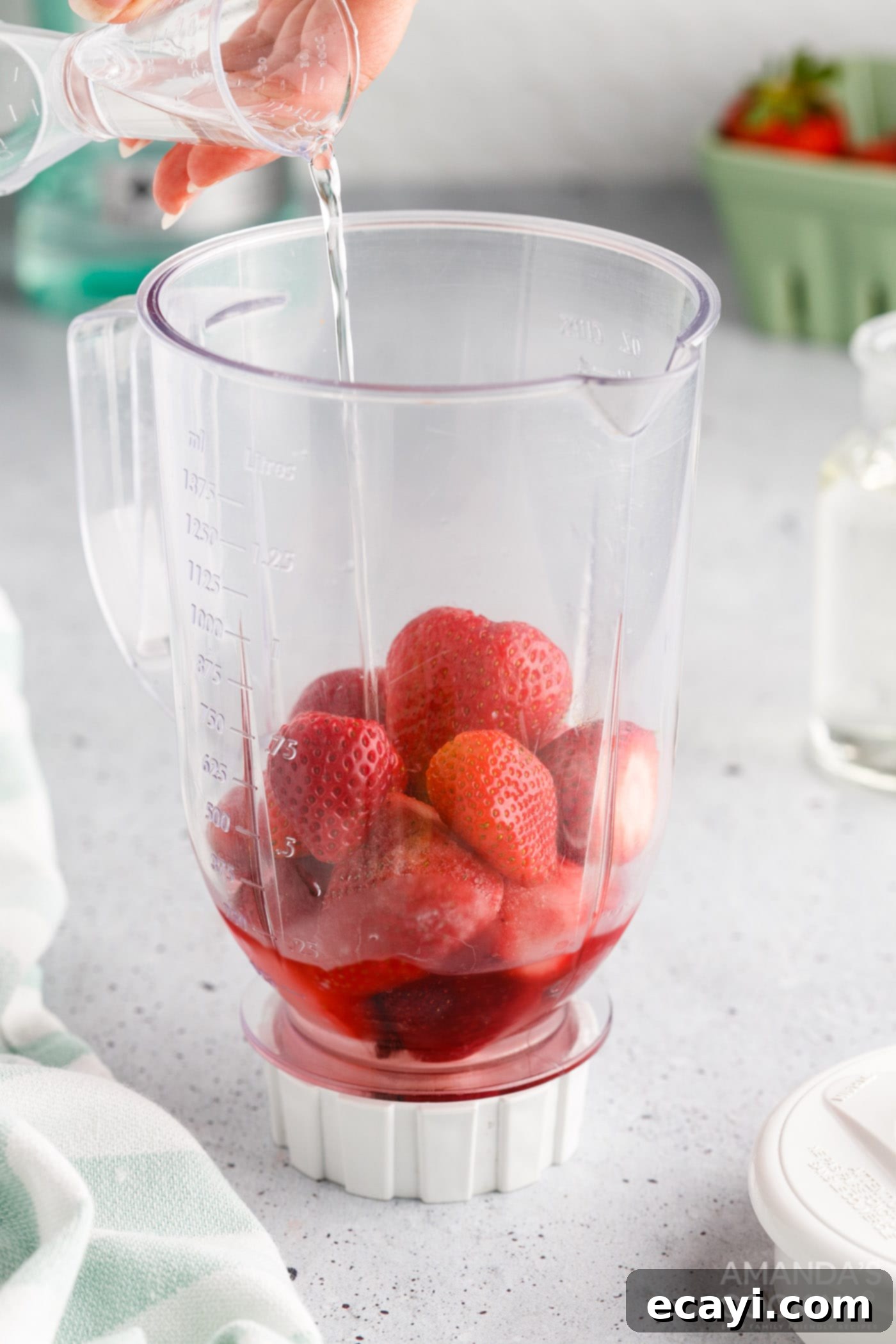 Frozen Strawberry Delight 5 pouring simple syrup into strawberry daiquiri blender