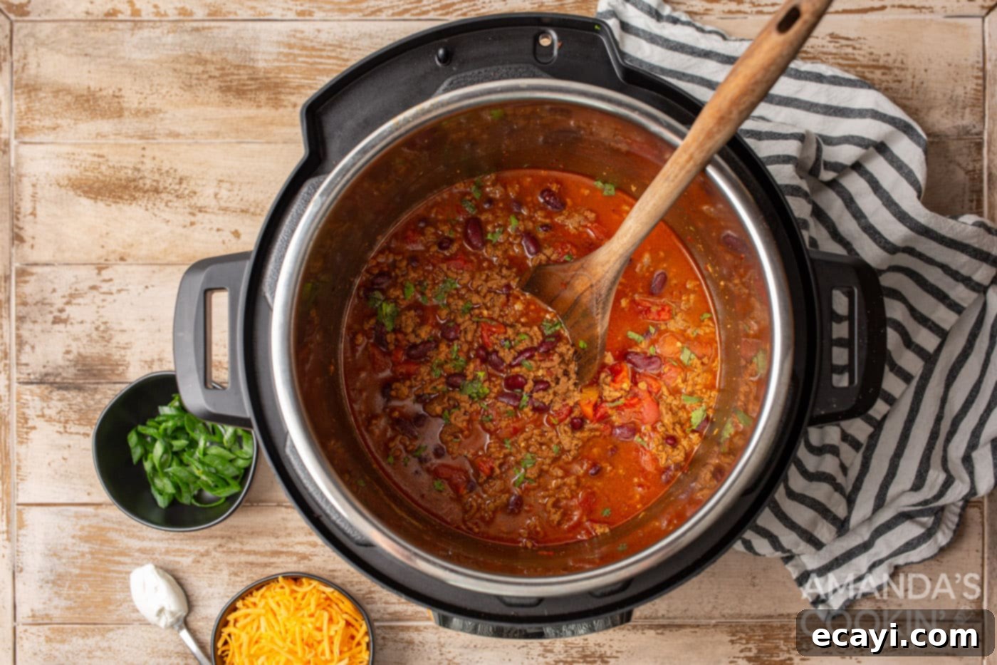 One-Pot Wonder Chili 7 chili in the instant pot with wooden spoon