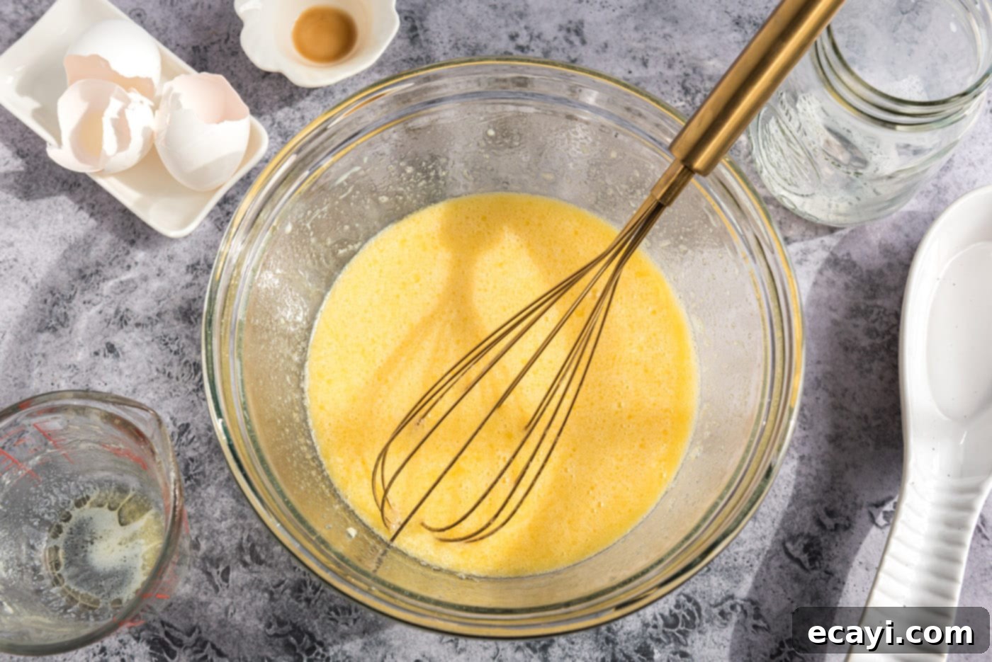 Sparkling Sugar Plum Muffins 8 The perfectly whisked egg, milk, vanilla, and melted butter mixture in a bowl, ready to be combined with dry ingredients.