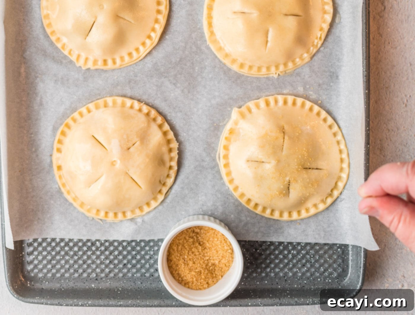 Golden Apple Pockets 10 Brushing apple hand pies with egg wash and sprinkling with sugar