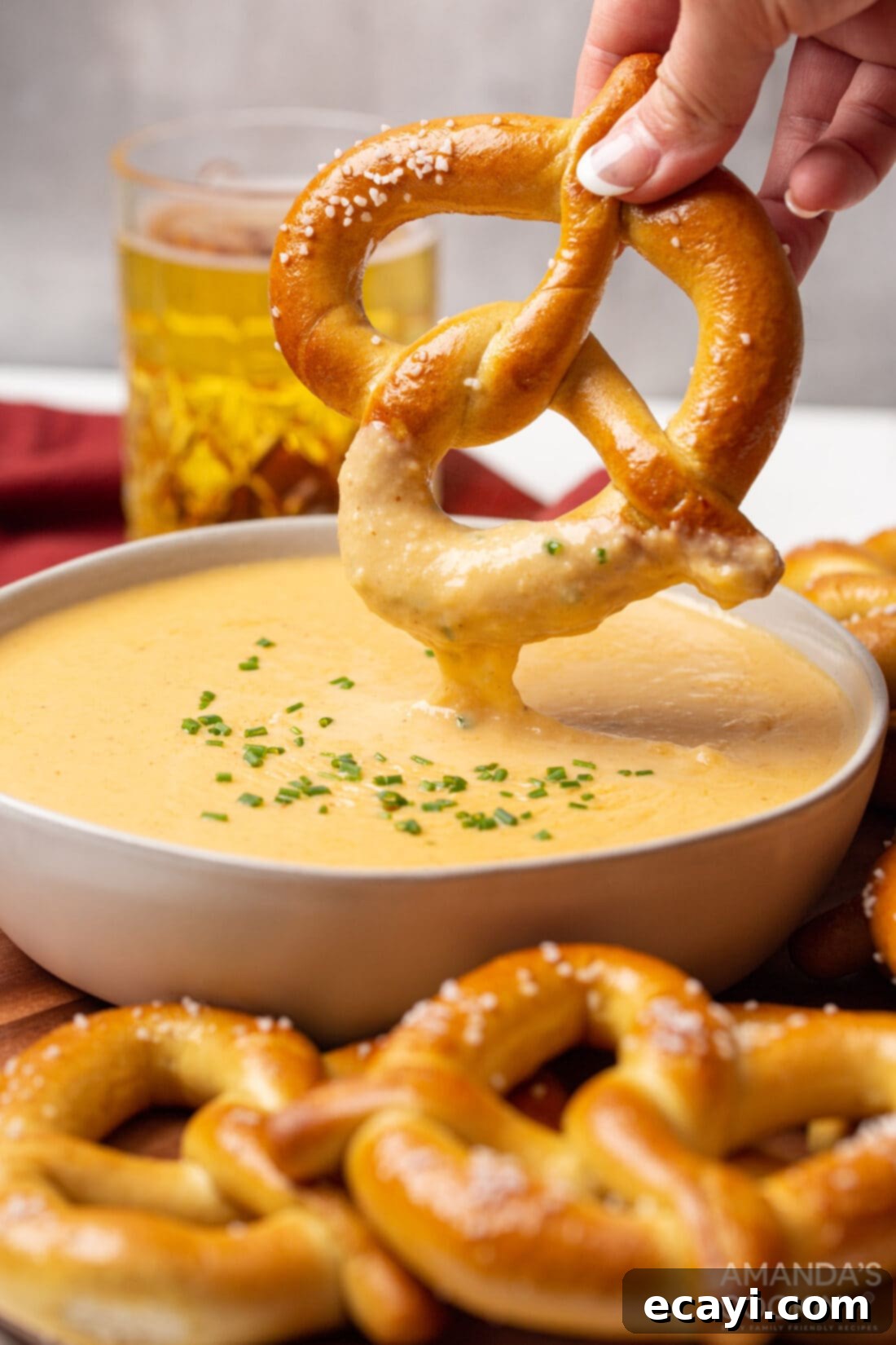 Hoppy Cheese Indulgence 2 dipping pretzel in beer cheese dip