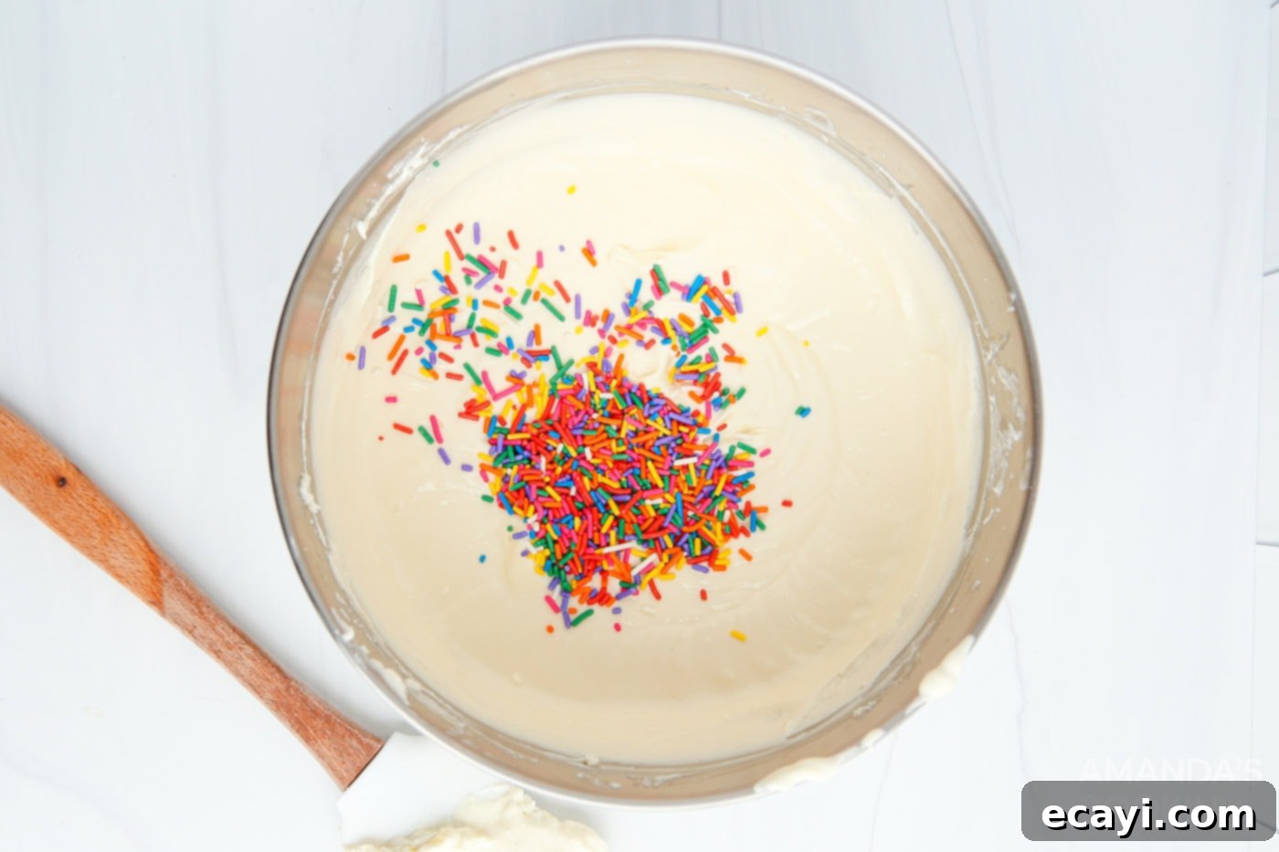 Effortless Instant Pot Funfetti Cheesecake 6 Cream cheese mixture with funfetti sprinkles in a mixing bowl