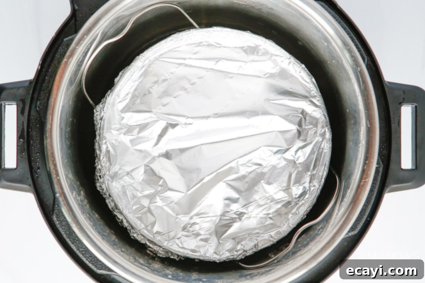 Effortless Instant Pot Funfetti Cheesecake 8 Instant Pot Funfetti Cheesecake wrapped in aluminum foil, inside the Instant Pot