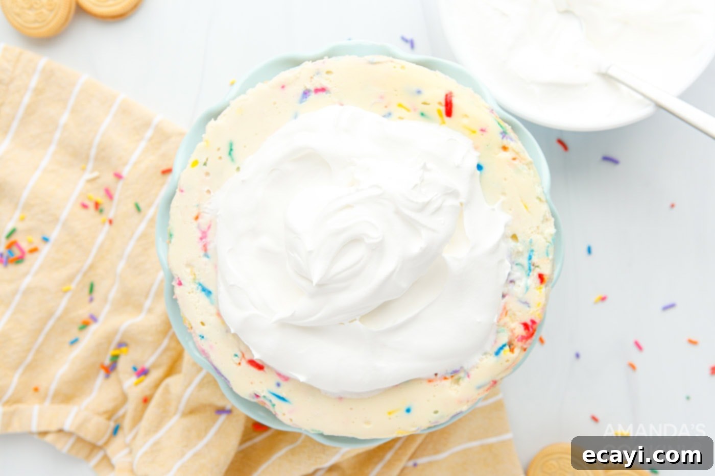 Effortless Instant Pot Funfetti Cheesecake 10 Whipped cream dollop on top of Instant Pot Funfetti Cheesecake