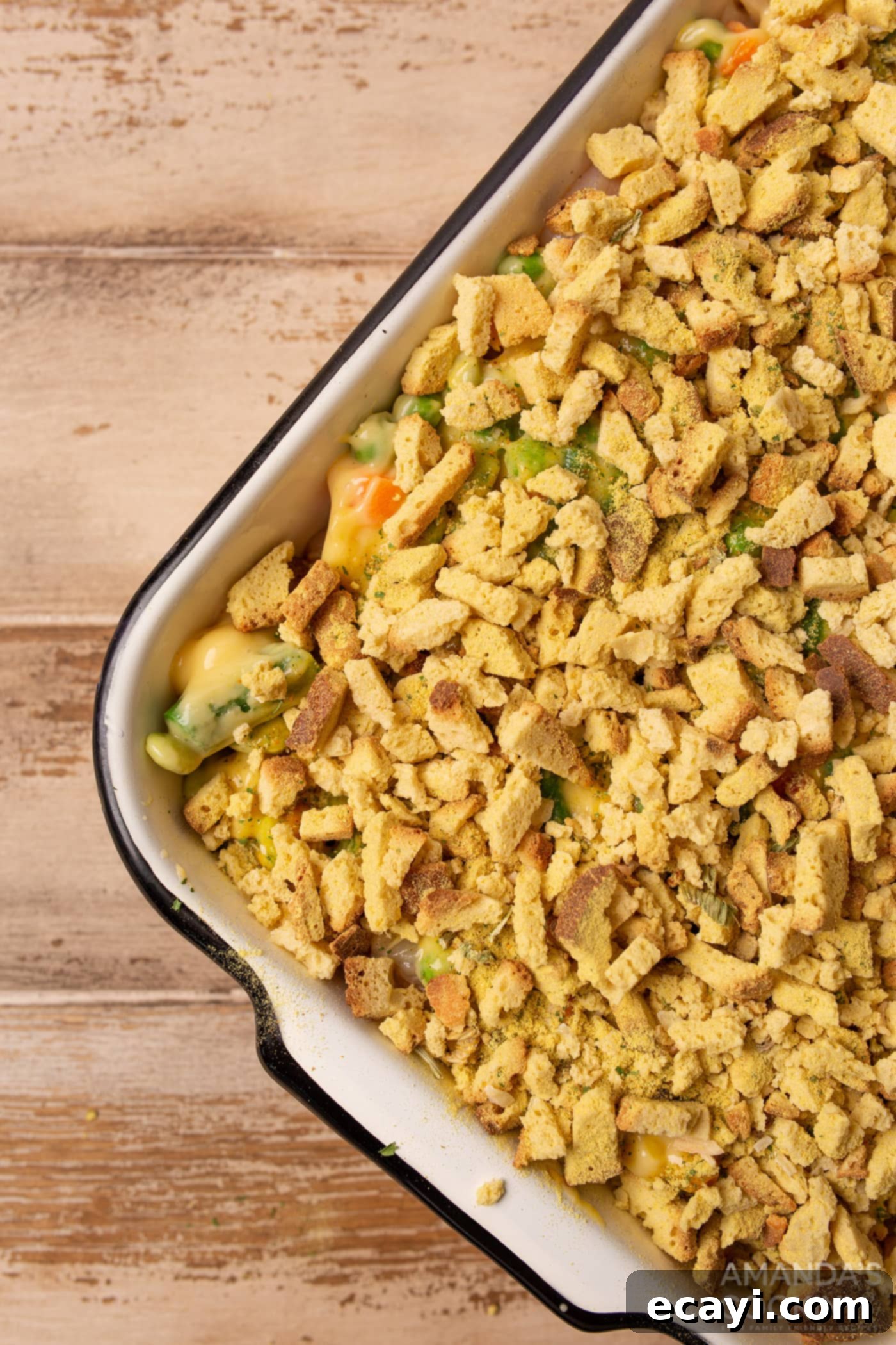 Savory Chicken and Stuffing Bake 6 dried bread cubes on top of veggies and chicken in a casserole dish