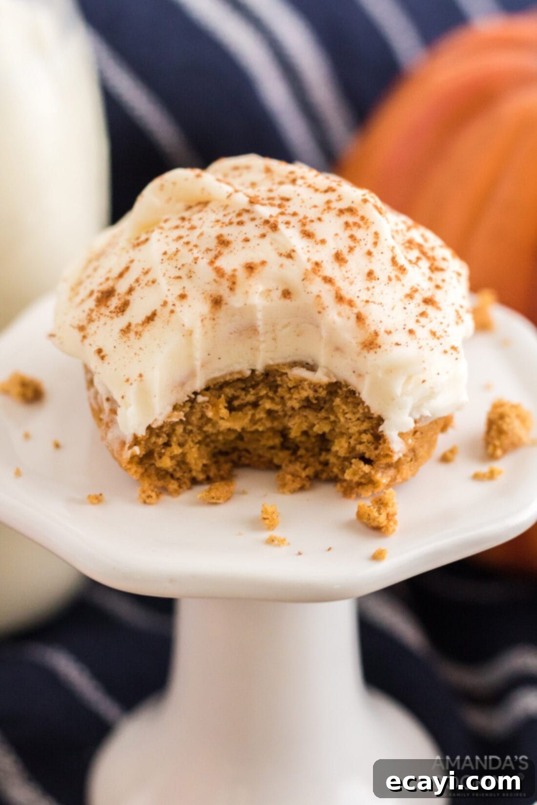 Easy Pumpkin Cake Mix Cookies 3 Close-up of a Pumpkin Cake Mix Cookie with a bite taken out, showing its soft texture and frosting