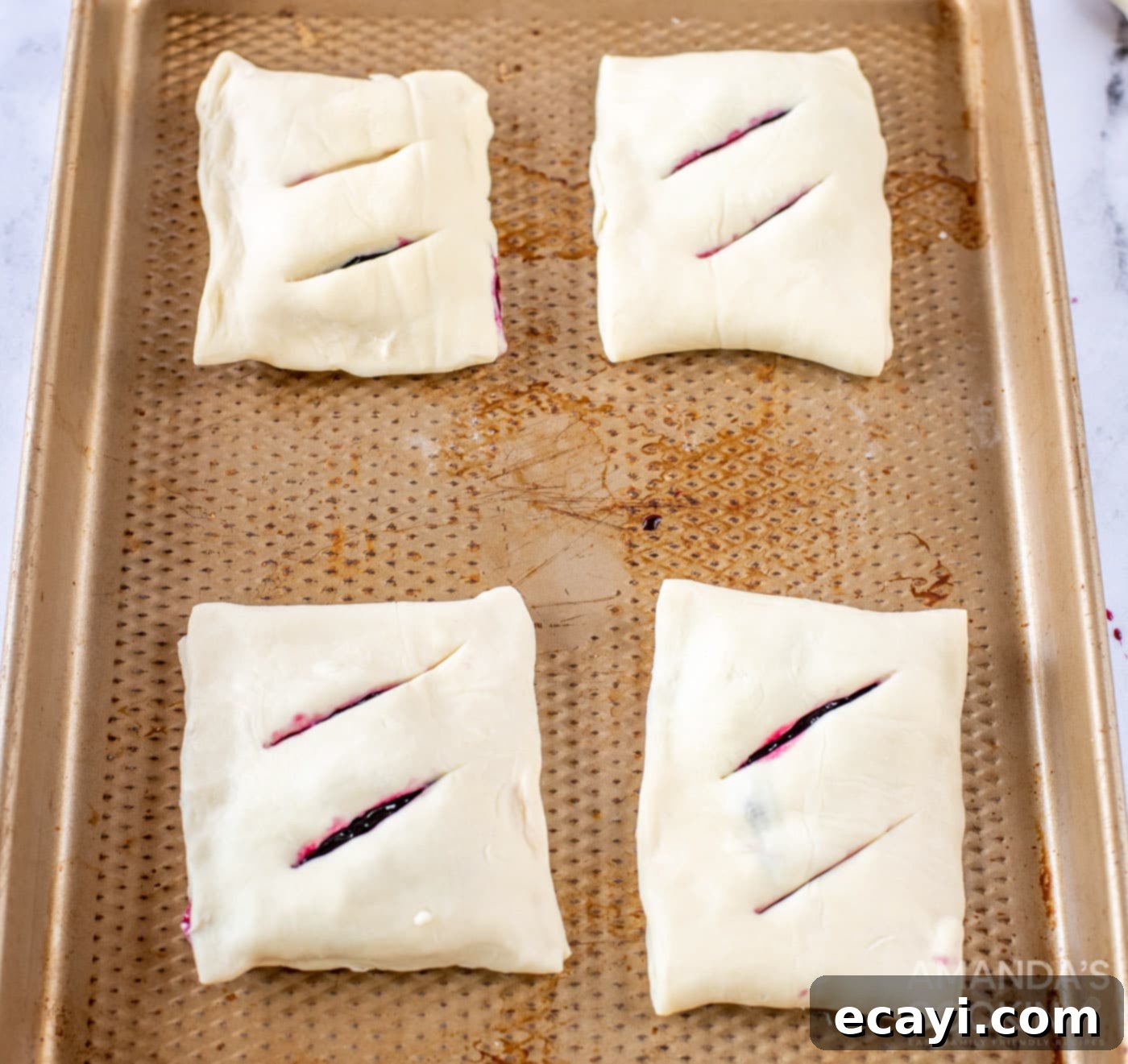 Sunshine Berry Pastry Pockets 9 lemon blueberry hand pies on a baking sheet