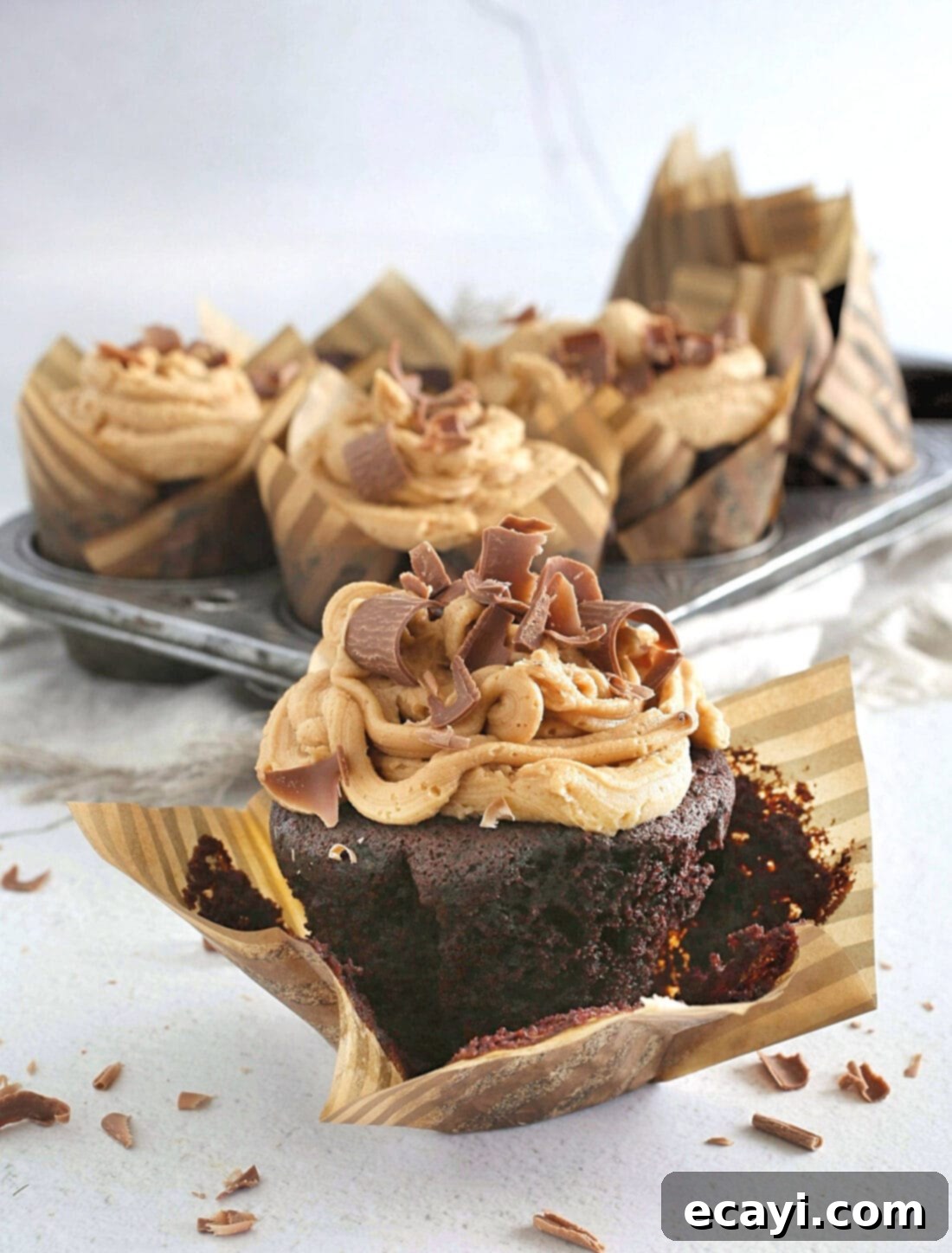 Irresistible Chocolate Peanut Butter Cupcakes 2 Decadent chocolate cupcake with a generous swirl of peanut butter frosting and chocolate shavings