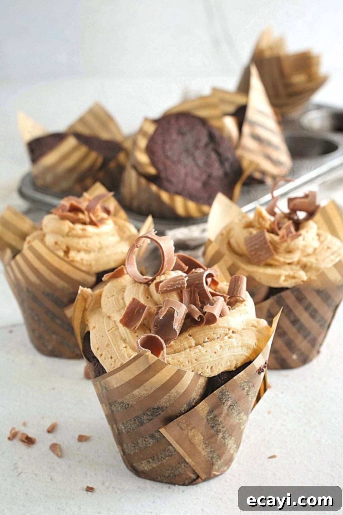 Irresistible Chocolate Peanut Butter Cupcakes 3 A perfectly baked Chocolate Peanut Butter Cupcake nestled in a paper wrapper, ready to be devoured.