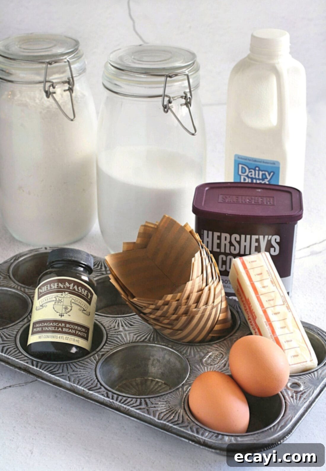 Irresistible Chocolate Peanut Butter Cupcakes 4 A collection of ingredients laid out, ready for making delicious Chocolate Peanut Butter Cupcakes, including butter, eggs, flour, cocoa, and peanut butter.