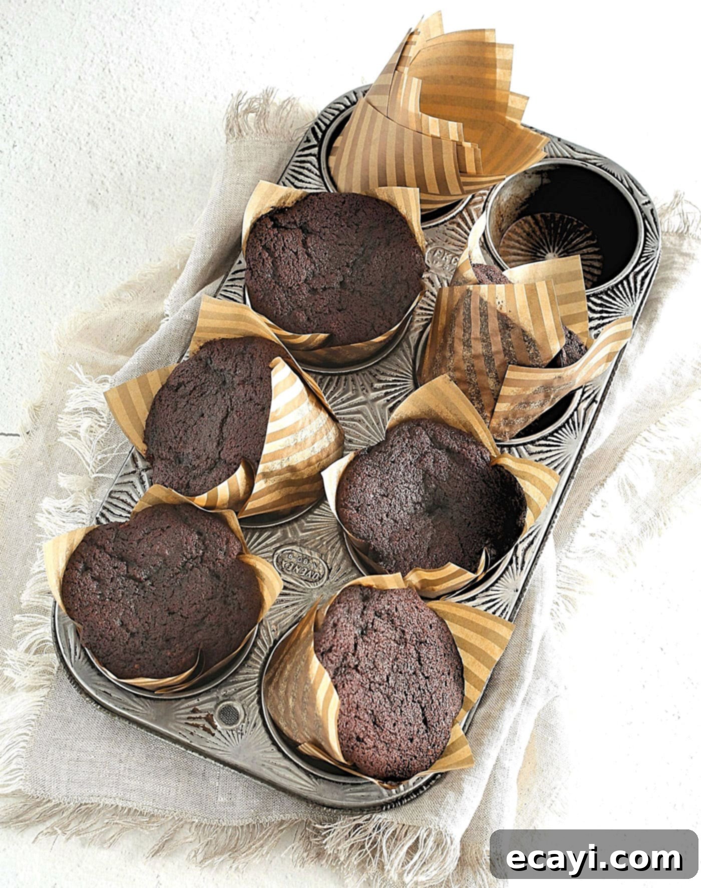 Irresistible Chocolate Peanut Butter Cupcakes 5 Freshly baked chocolate cupcakes cooling in a muffin pan