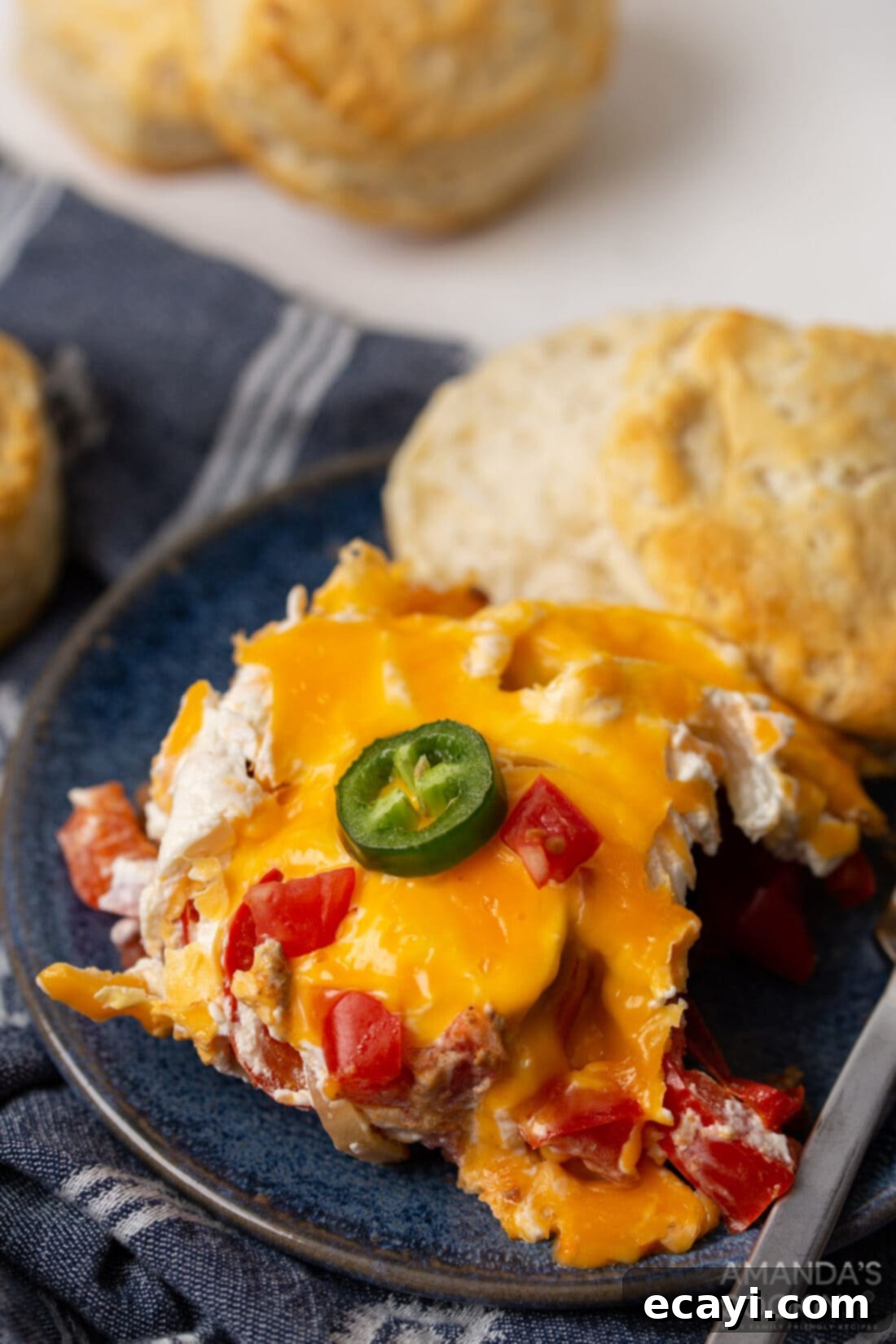 Hearty Slow Cooker John Wayne Casserole 3 crockpot john wayne casserole with a biscuit on a plate