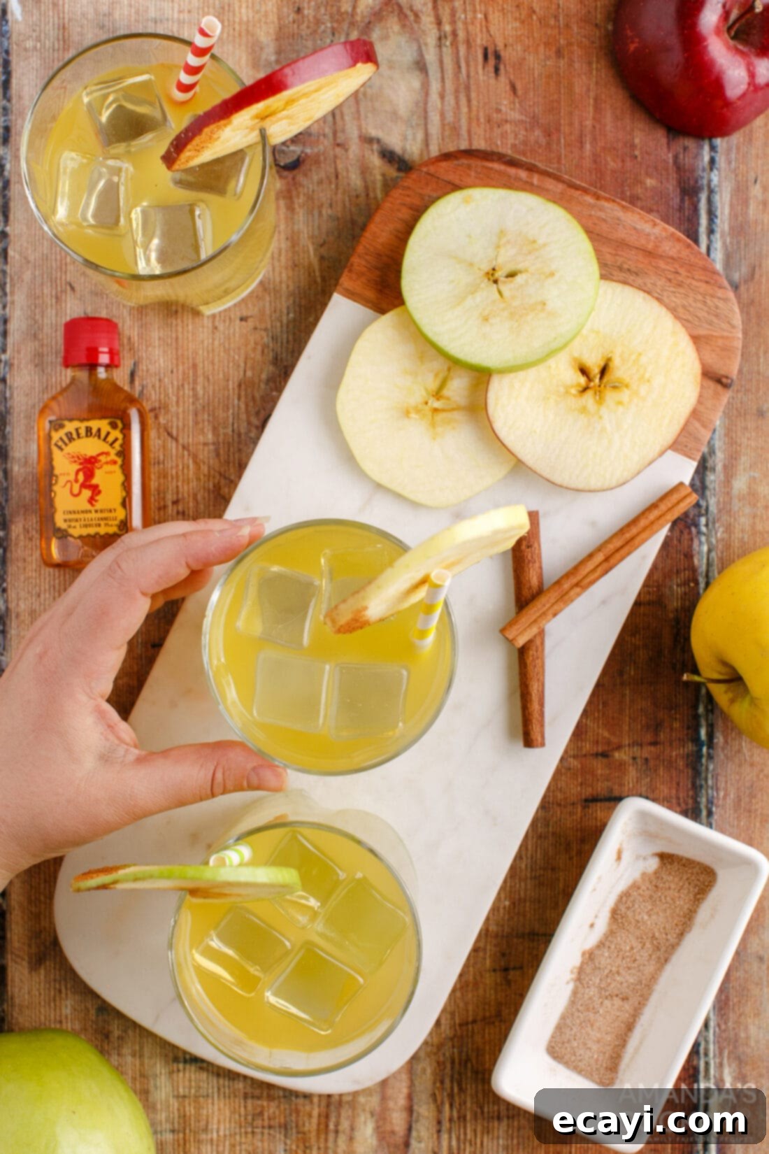 Harvest Spice Apple Elixir 9 hand reaching for a Cinnamon Applesauce Cocktail glass