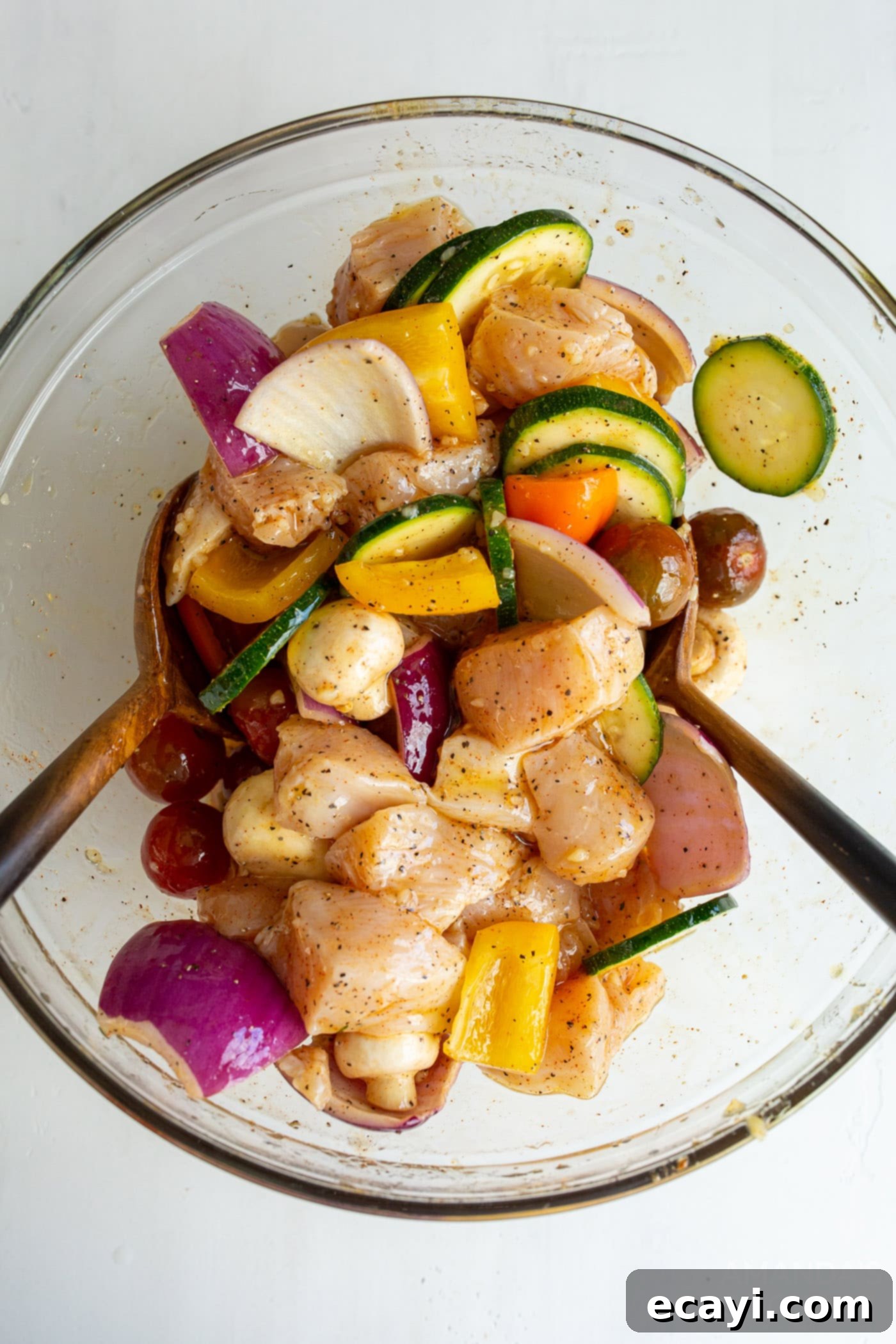 Effortless Air Fryer Chicken Kabobs 6 Chicken and vegetables mixed with marinade in a large bowl