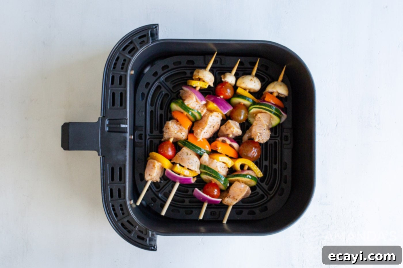 Effortless Air Fryer Chicken Kabobs 7 Assembled chicken kabobs placed in an air fryer basket