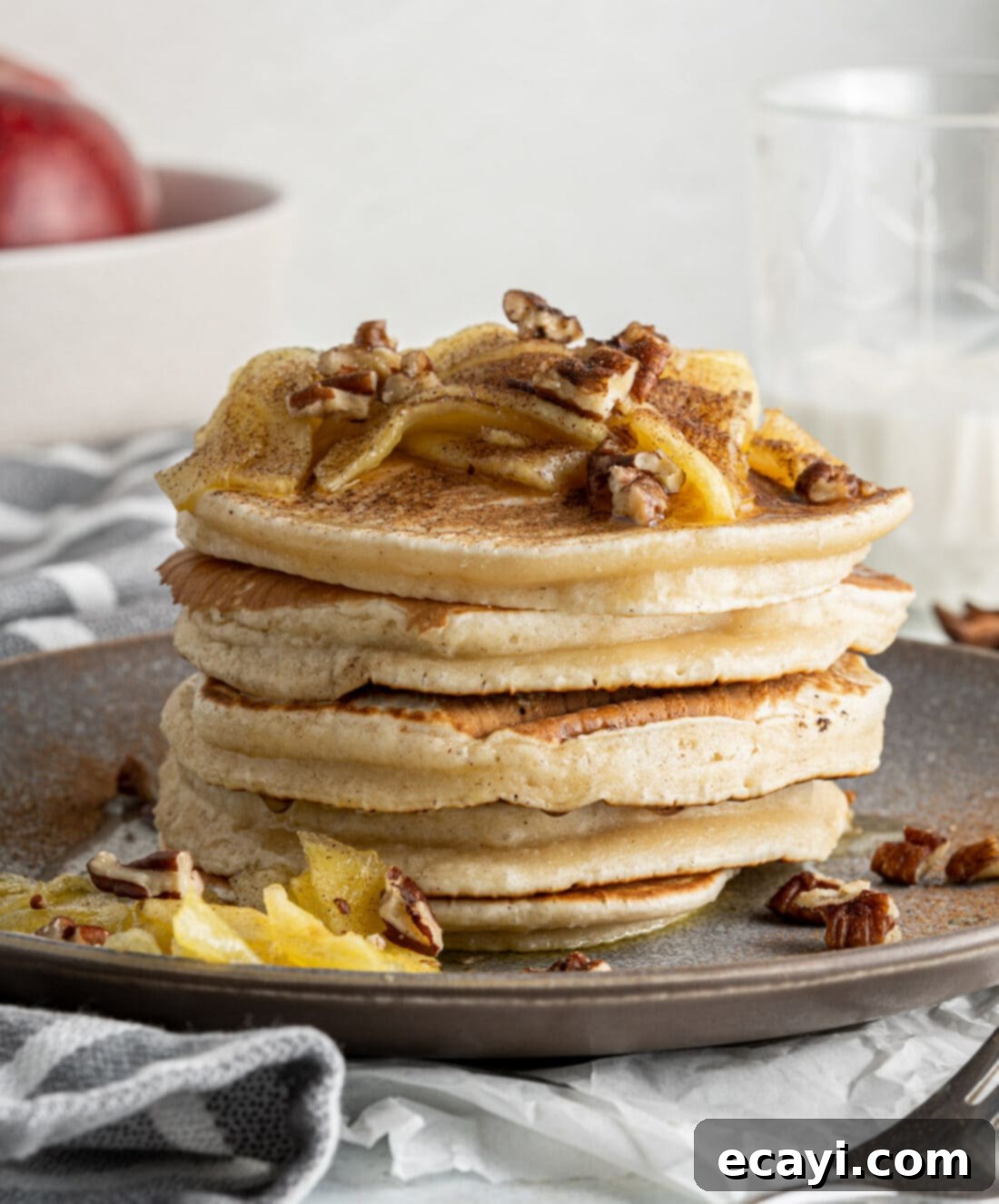 Fluffy Apple Pancakes 3 Stack of cinnamon apple pancakes with caramelized apples and a dusting of powdered sugar