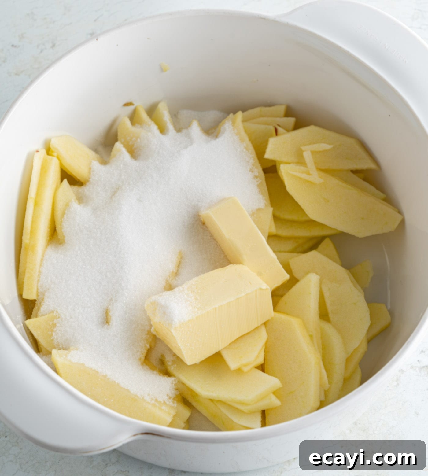 Fluffy Apple Pancakes 5 Sliced apples, sugar, water, and butter in a pot before cooking