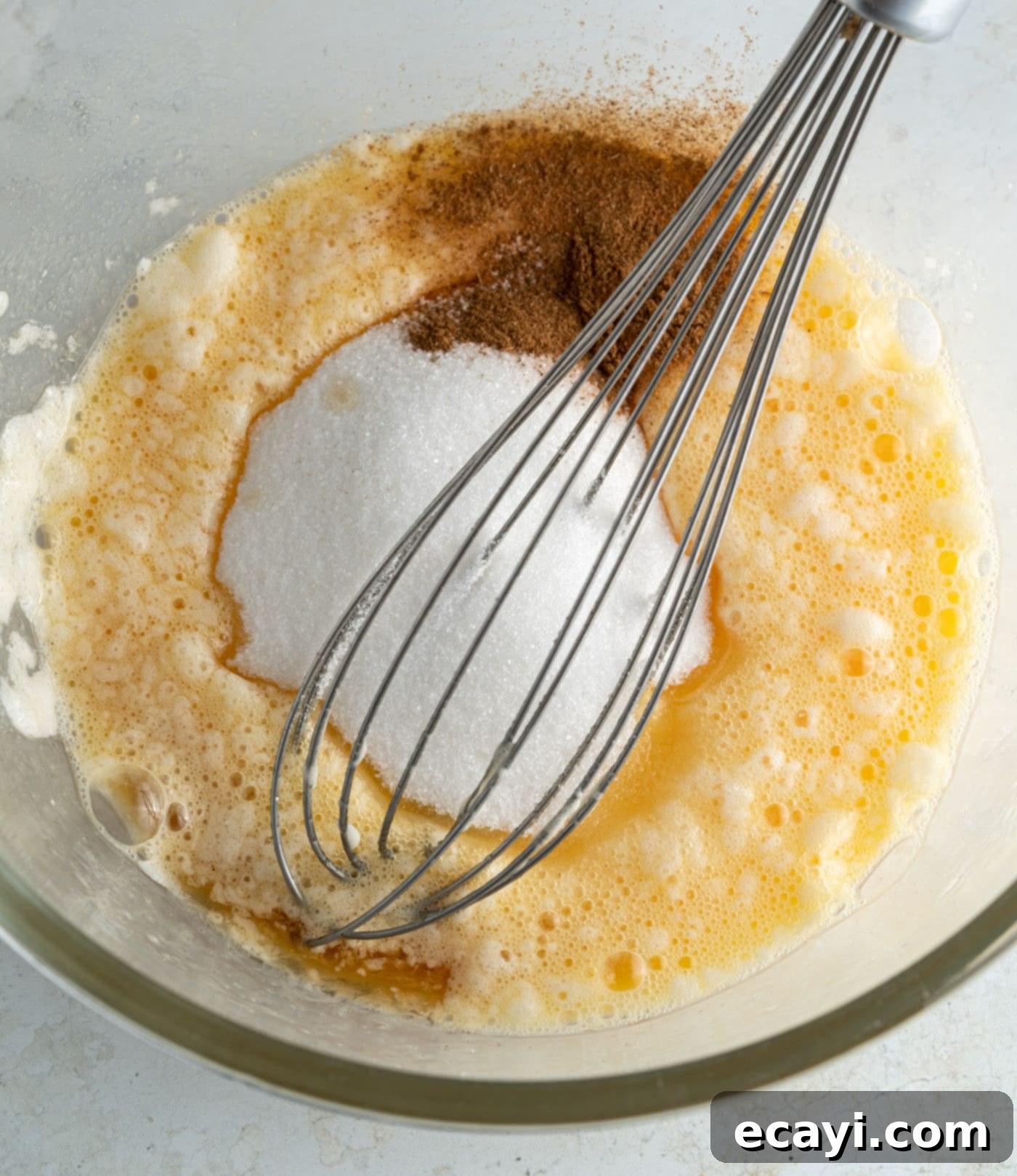 Fluffy Apple Pancakes 7 Pancake batter ingredients being whisked in a bowl