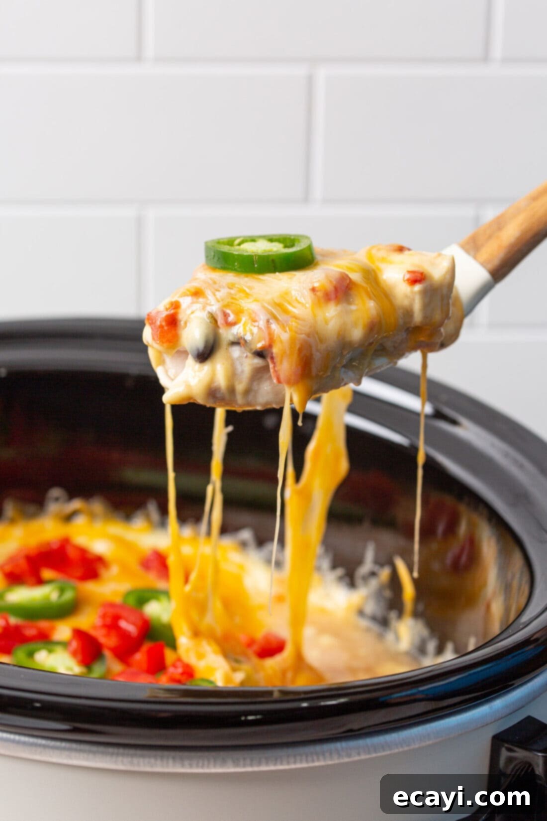 Slow Cooker Mexican Shredded Chicken 3 spoon lifting mexican chicken from crockpot