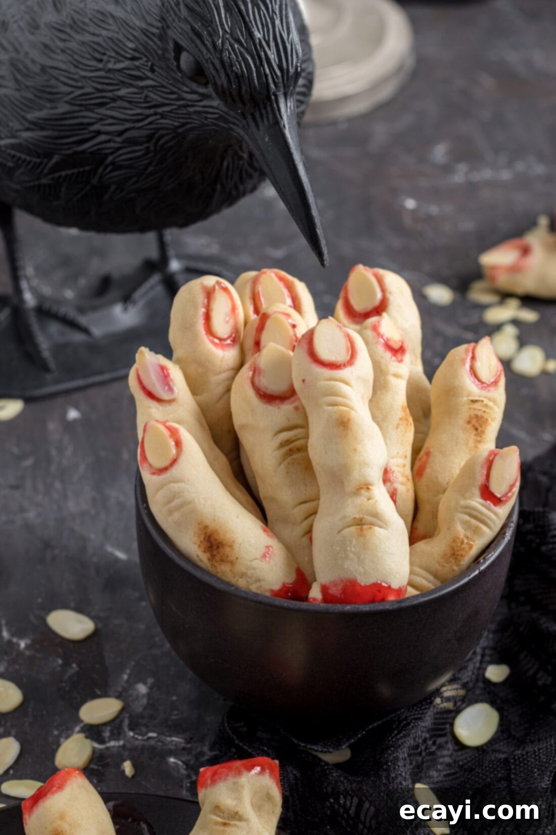 Wicked Fingers 2 Grotesque Witch Finger Cookies with strawberry jam blood in a white dish, ready for Halloween party serving