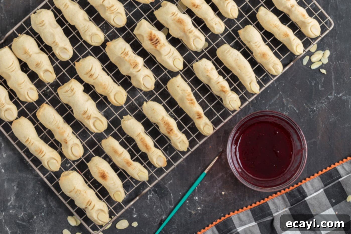 Wicked Fingers 14 Freshly baked Witch Finger Cookies cooling, showing their grotesque shapes and almond fingernails
