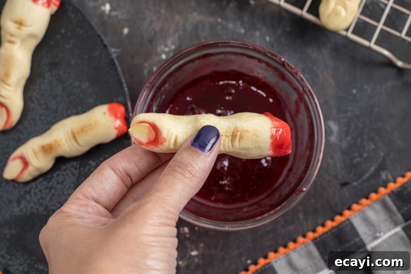 Wicked Fingers 16 Dipping the severed ends of Witch Finger Cookies into warm strawberry jam for a realistic